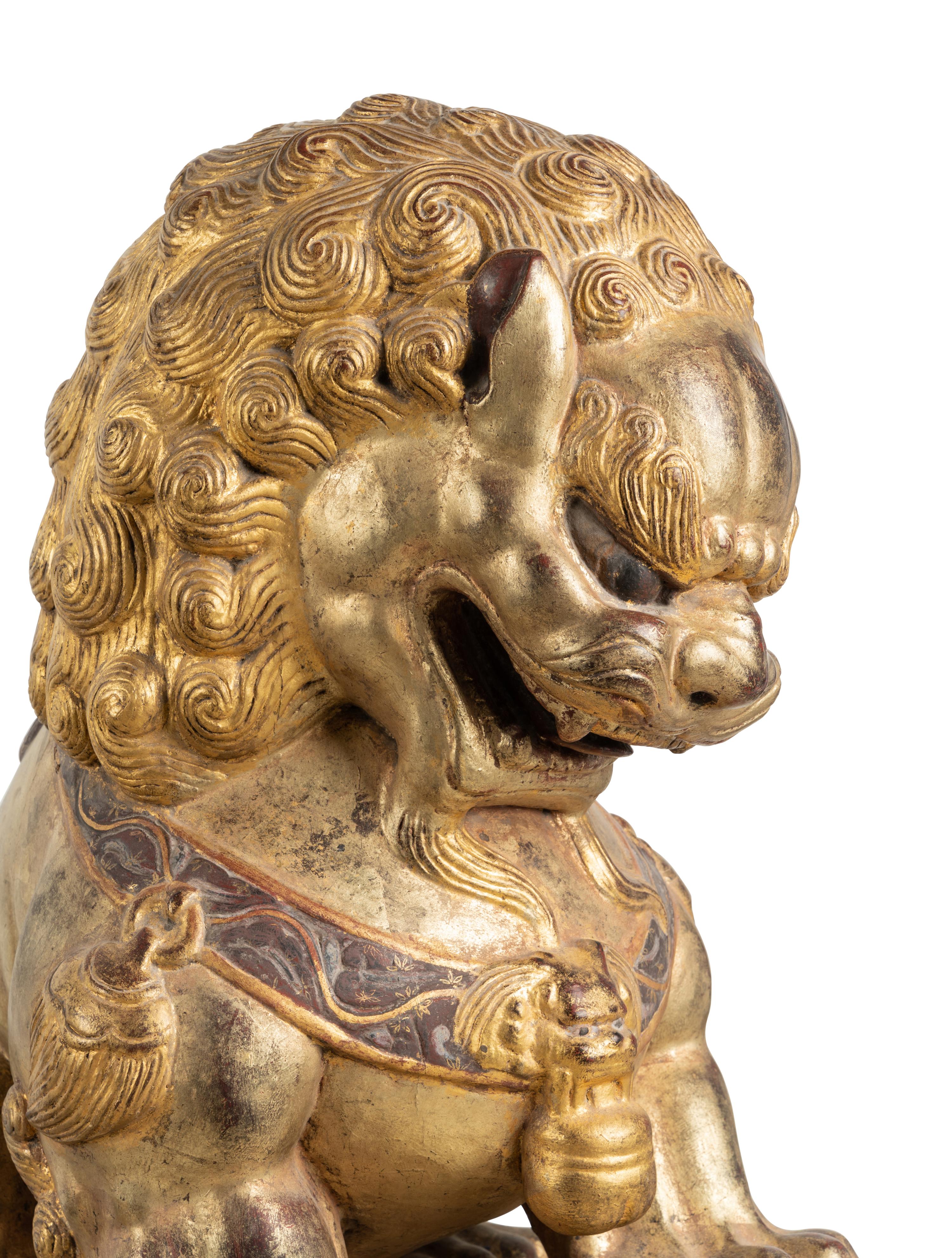 A Pair of Large Chinese Giltwood and Composition Buddhistic Lions