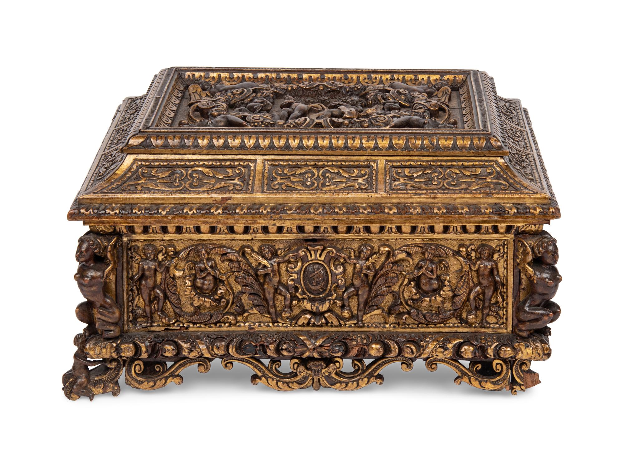 An Italian Parcel Gilt and Carved Walnut Orpheus and Eurydice Casket