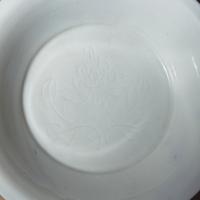 A Chinese Blanc-de-Chine Porcelain Bowl and an Incised 'Peony' Shallow Dish, Ming-Qing Dynasty — 明-清 德化白瓷碗及暗刻牡丹紋碟
