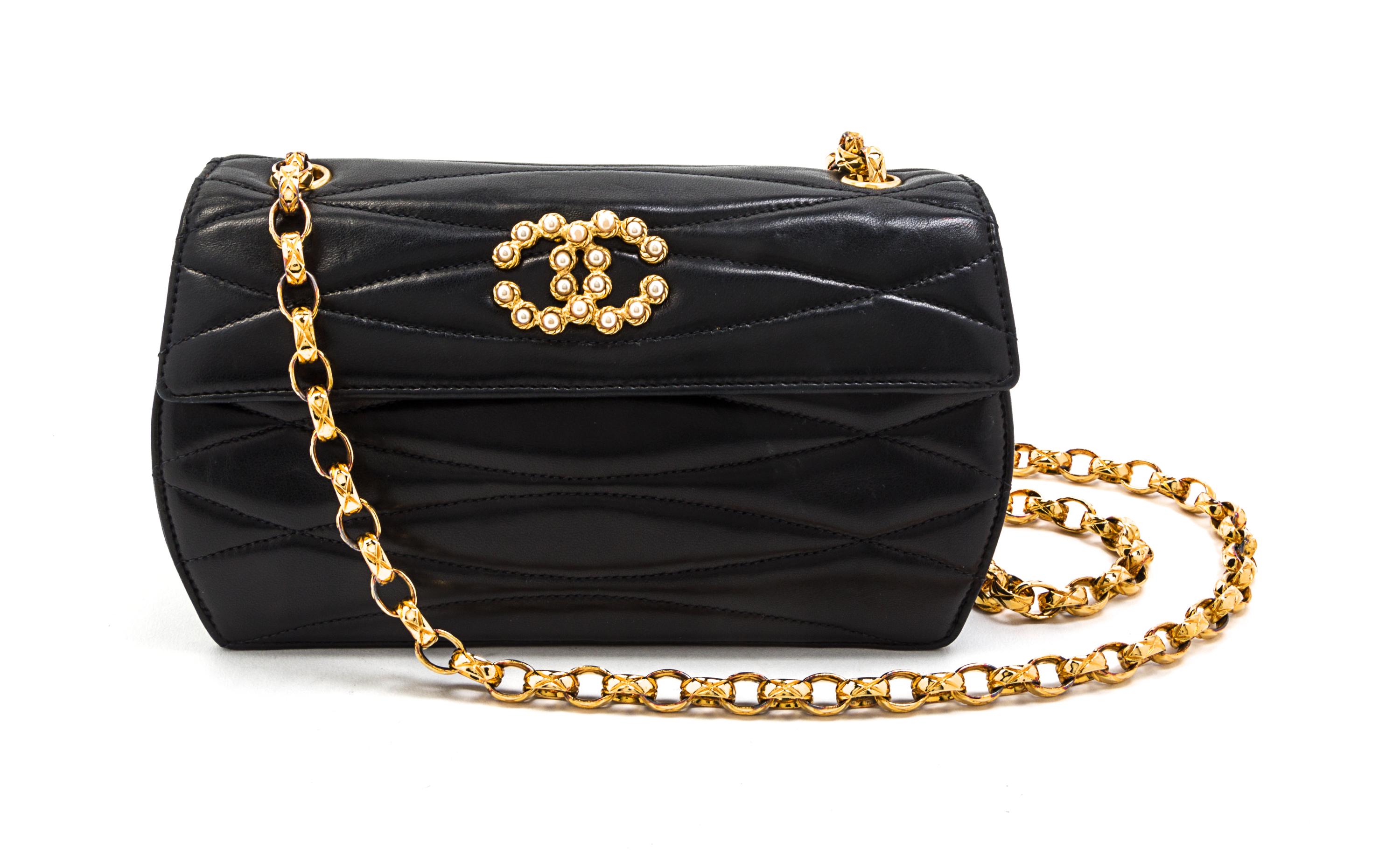 A Chanel Black Quilted Leather and Faux Pearl Flap Bag, 7 1/2 x 4 1/2 x 2 1/2 inches.