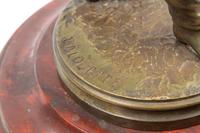 A French Patinated Bronze and Rouge Marble Figural Mantel Clock