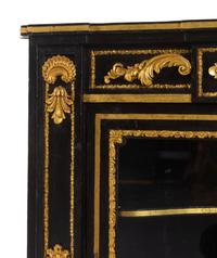 A Napoleon III Style Parcel Gilt and Ebonized Marble-Top Corner Cabinet