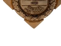 [OCCUPATIONAL]. National Surety Medal for Valor presented to African American police officer Leslie H. Carroll. New York: Tiffany & Co., 1943.