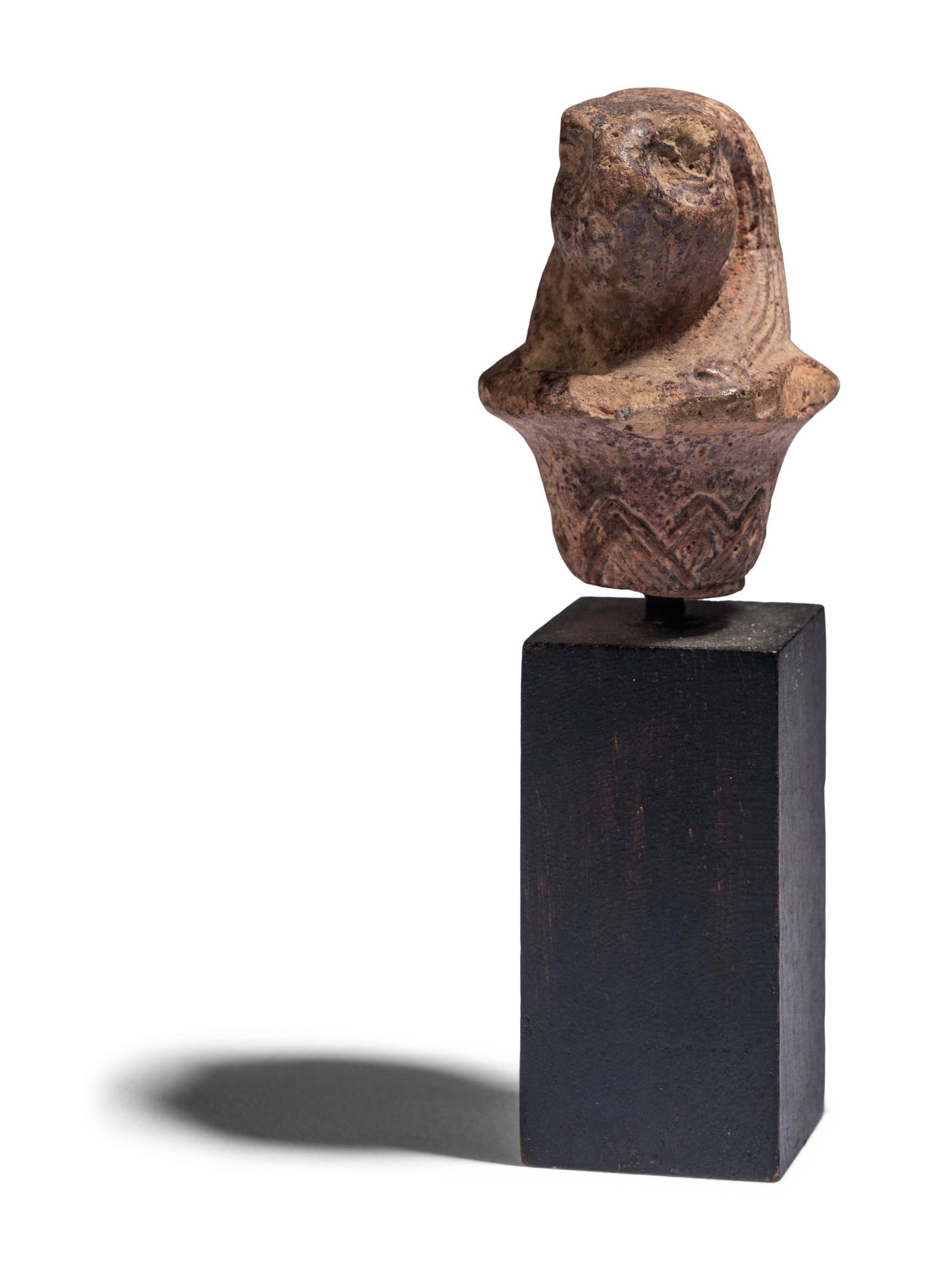 An Egyptian Stone Wadj Fragment with the Head of a Falcon