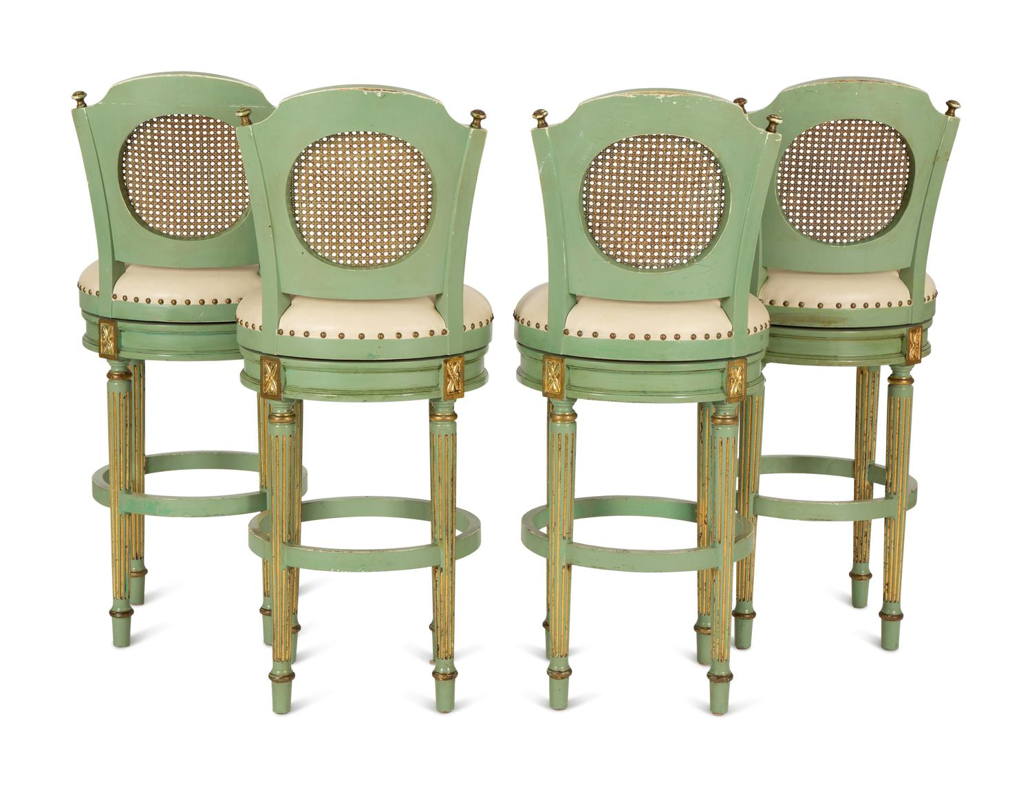 Four Louis XVI Style Painted, Parcel Gilt and Cane Back Bar Stools