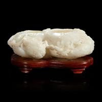 A Chinese carved white jade double-gourd washer with wood stand