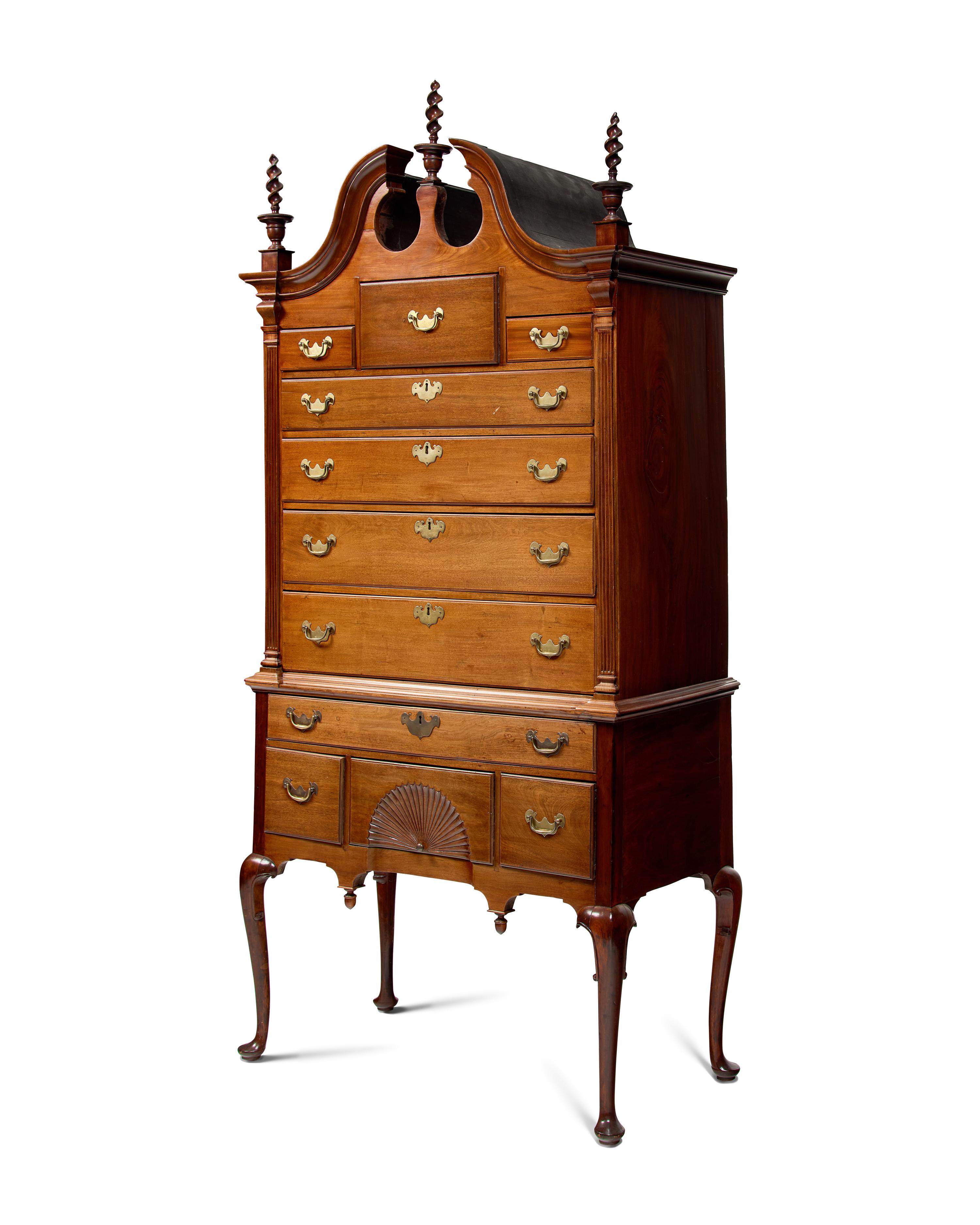 A Queen Anne Carved Walnut Bonnet-Top High Chest of Drawers