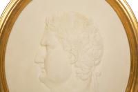 A Pair of Roman Style Composition Relief Plaques in Giltwood Frames