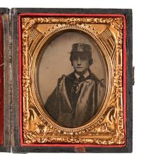 [CIVIL WAR]. Ninth plate ambrotype portrait of a young boy wearing an oil cloth cape and hat cover.