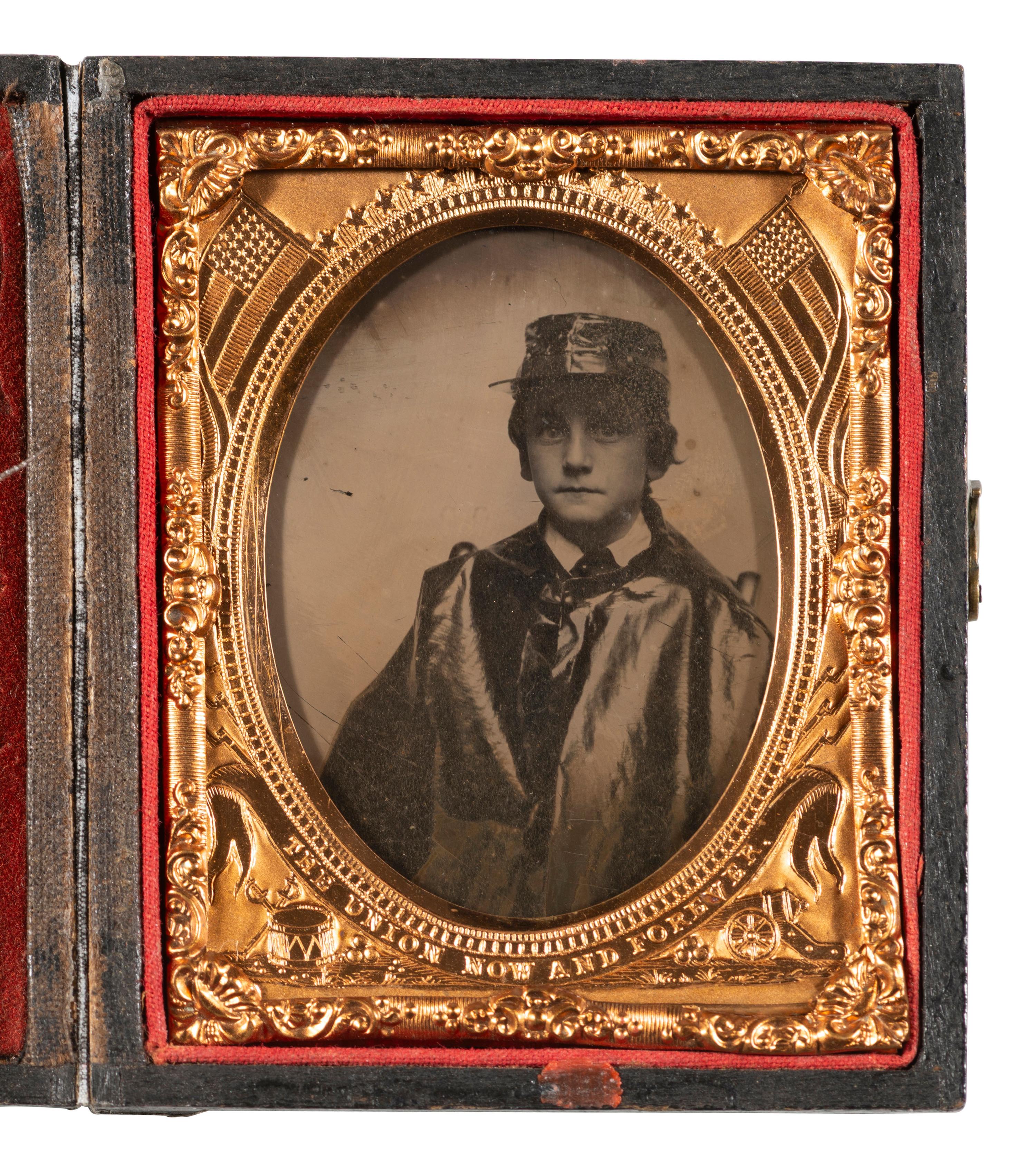 [CIVIL WAR]. Ninth plate ambrotype portrait of a young boy wearing an oil cloth cape and hat cover.