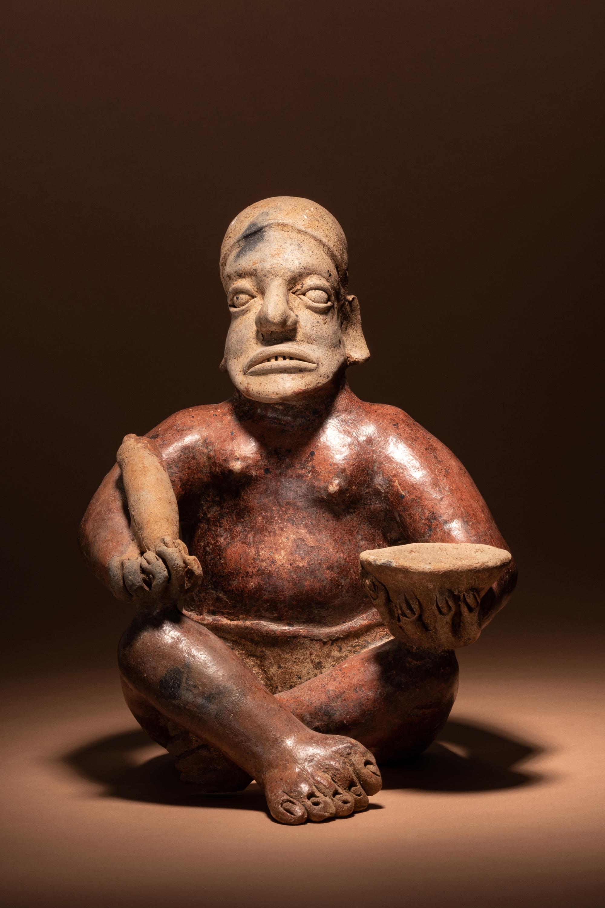 A Jalisco Seated Figure with Offerings