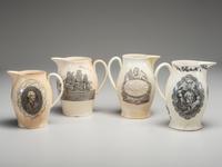 A Wedgwood Britannia and Etruria Panel and Nautical Creamware Pitchers