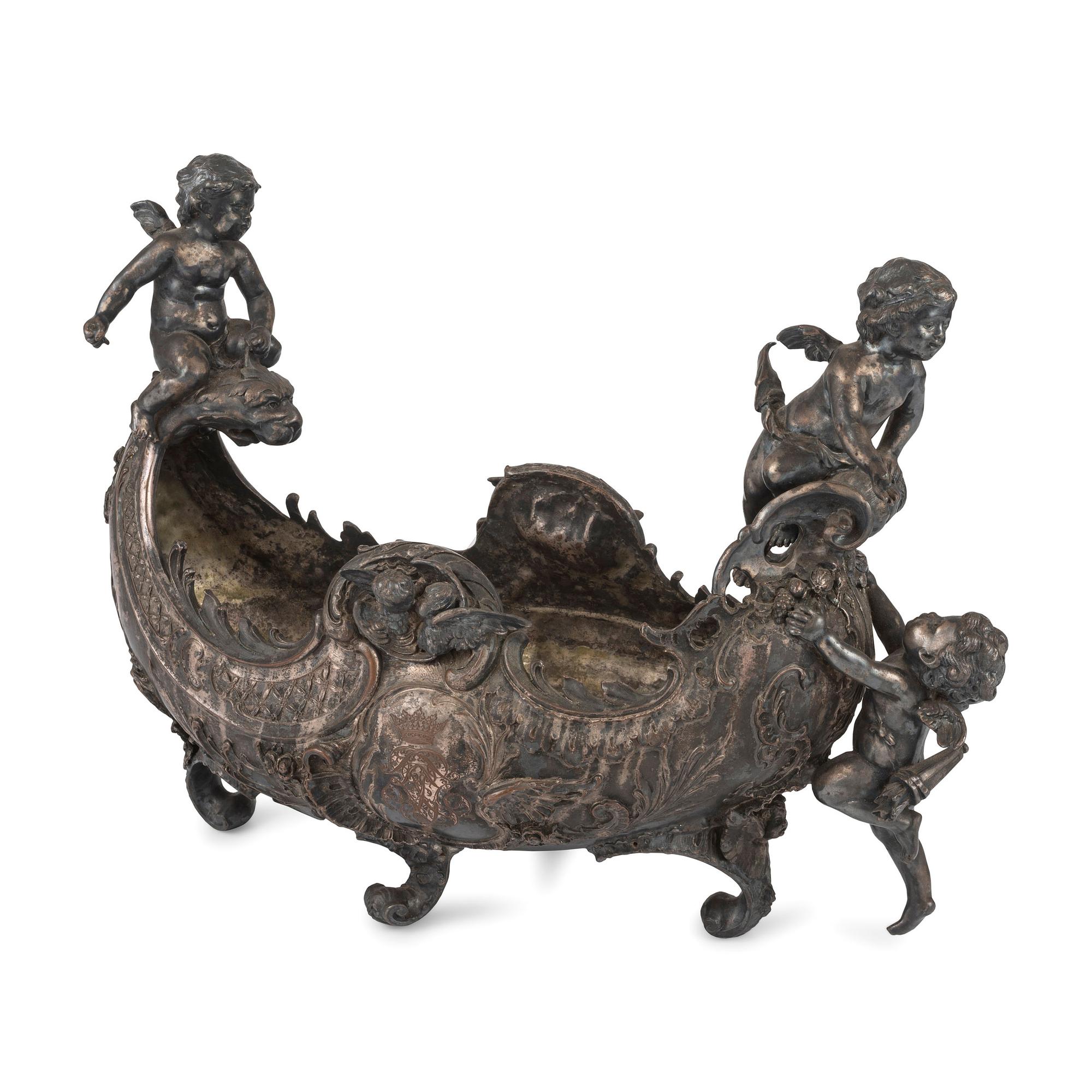 An Ornate Silverplate Centerpiece Bowl of Boat Form with Cherubs