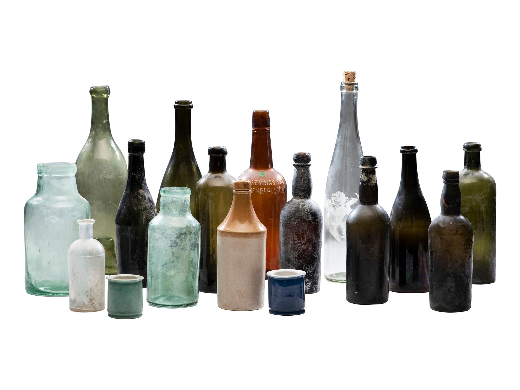 [AMERICANA]. Assembled collection of American glass and ceramic liquor and utility bottles.