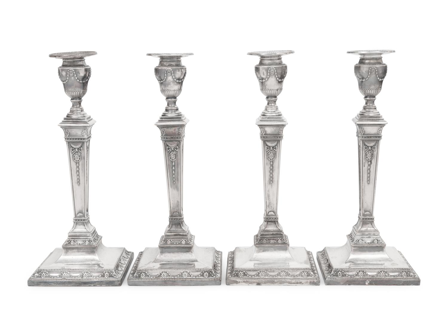 A Set of Four Silver-Plate Candlesticks
