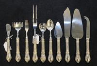 A Set of Ten Silver Handled Serving Articles, , comprising a cake slice, master butter knife, sugar scoop, bar knife, pickle fork, carv