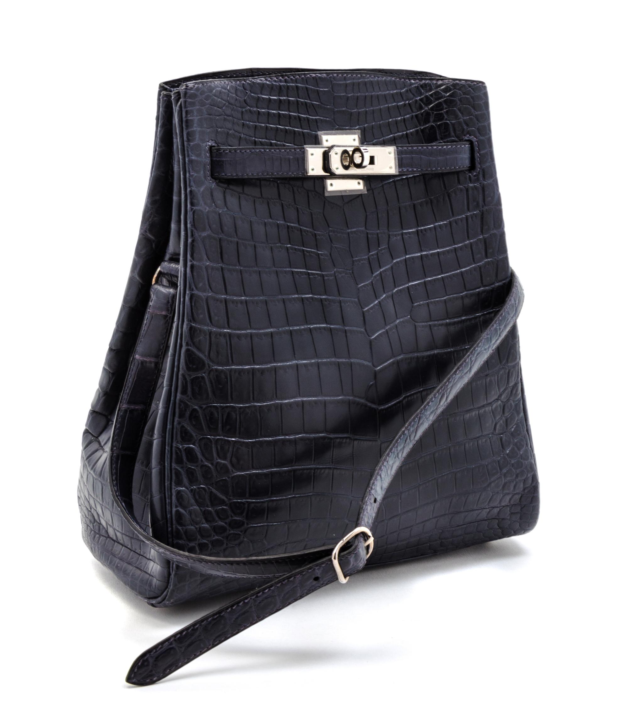 An Hermes 25cm Navy Niloticus Crocodile Kelly Sport Bag, 11 x 9 1/2 x 4 1/2 inches.