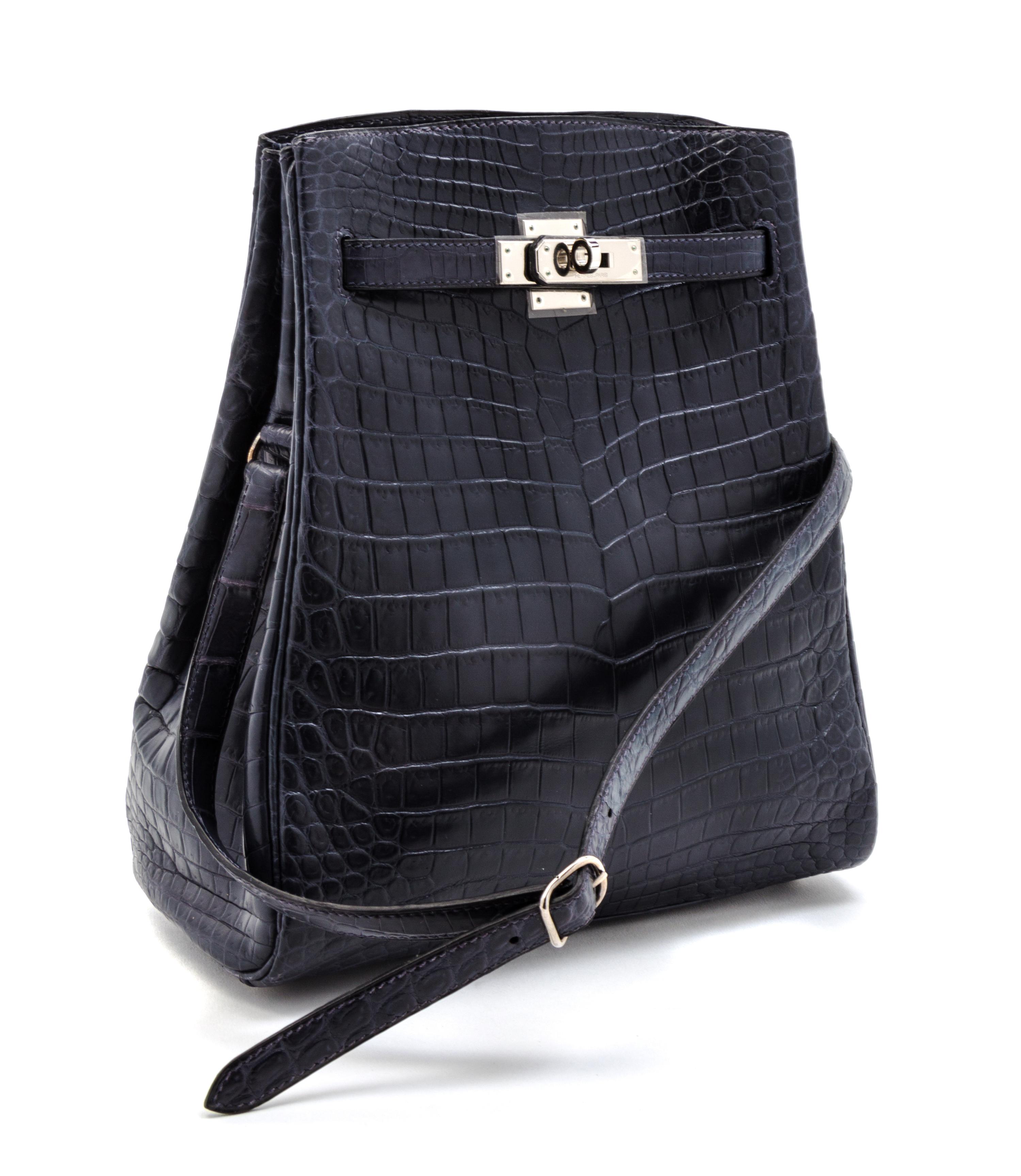An Hermes 25cm Navy Niloticus Crocodile Kelly Sport Bag, 11 x 9 1/2 x 4 1/2 inches.