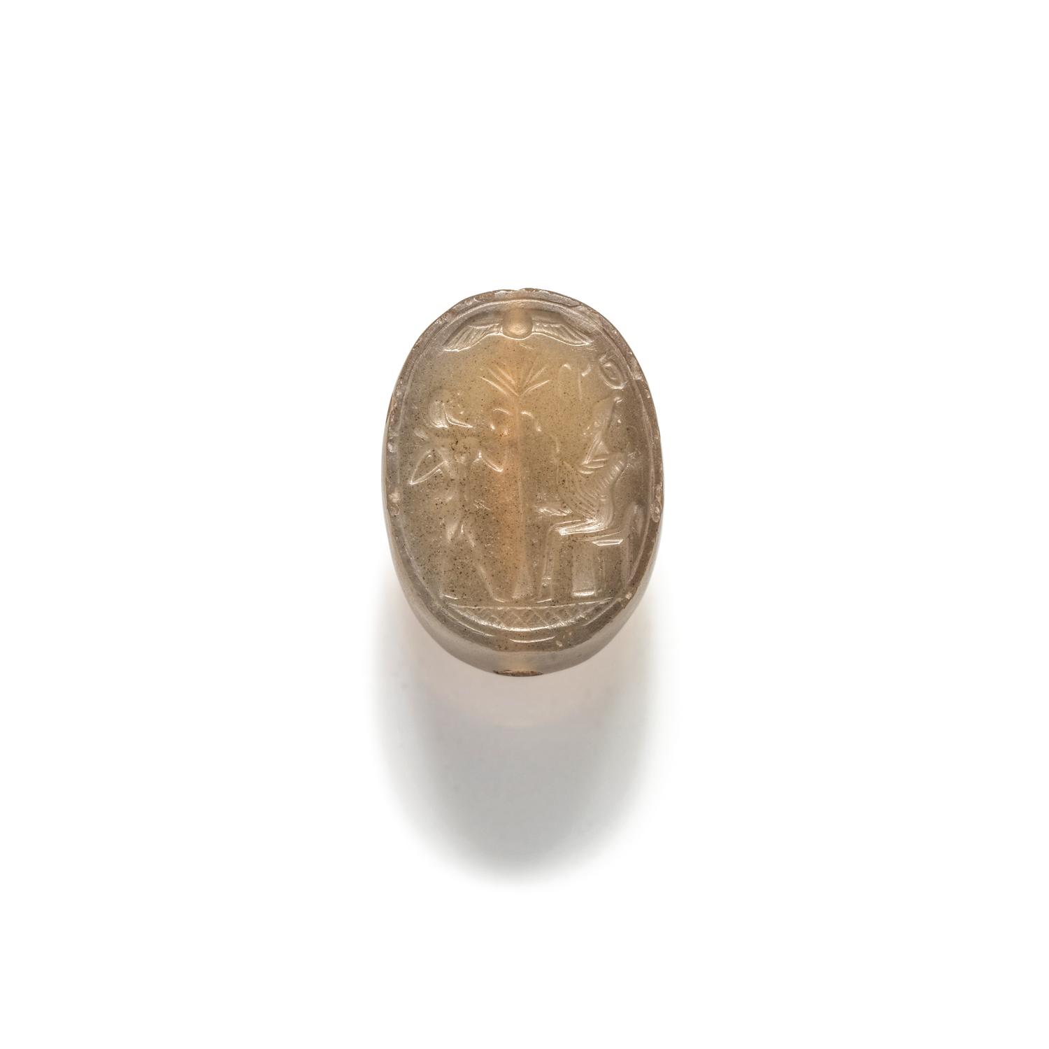 A Phoenician Carnelian Scaraboid with a Seated King and Hero