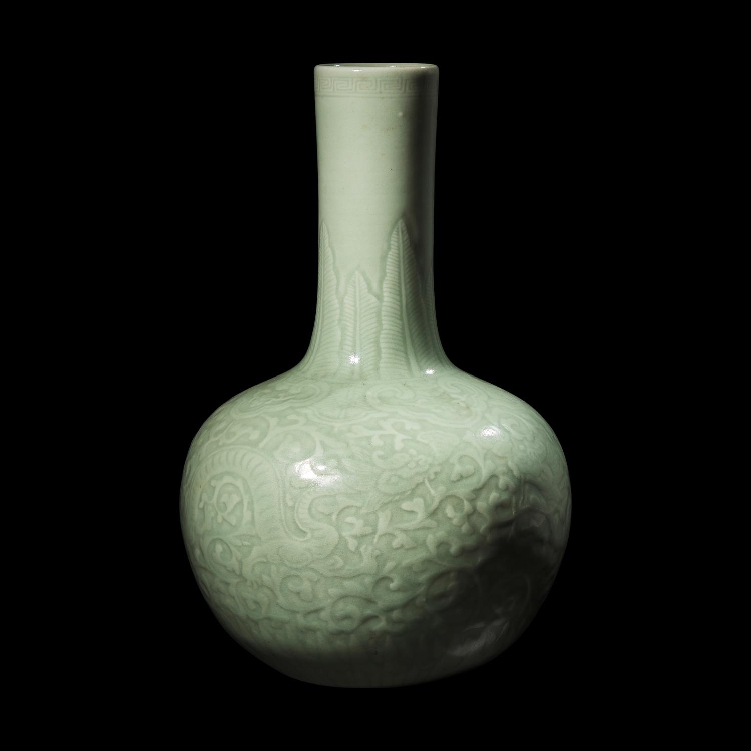 A Chinese Celadon Glazed Molded Porcelain Bottle Vase, Late Qing Dynasty 清晚期 粉青釉龍紋天球瓶