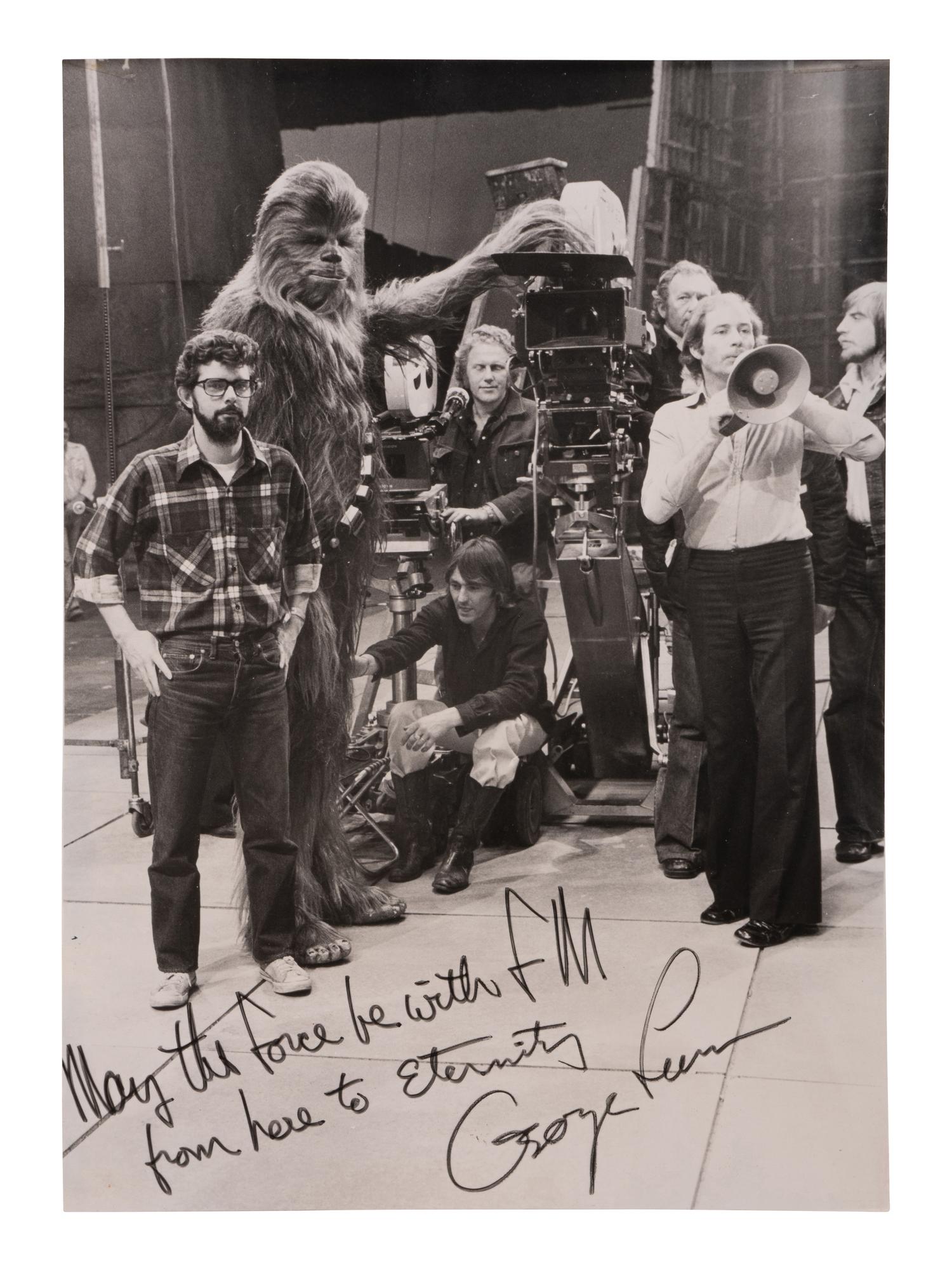 [LUCAS, George (b. 1944)]. Original photograph from the set of Star Wars with personal inscription from George Lucas. 1977.
