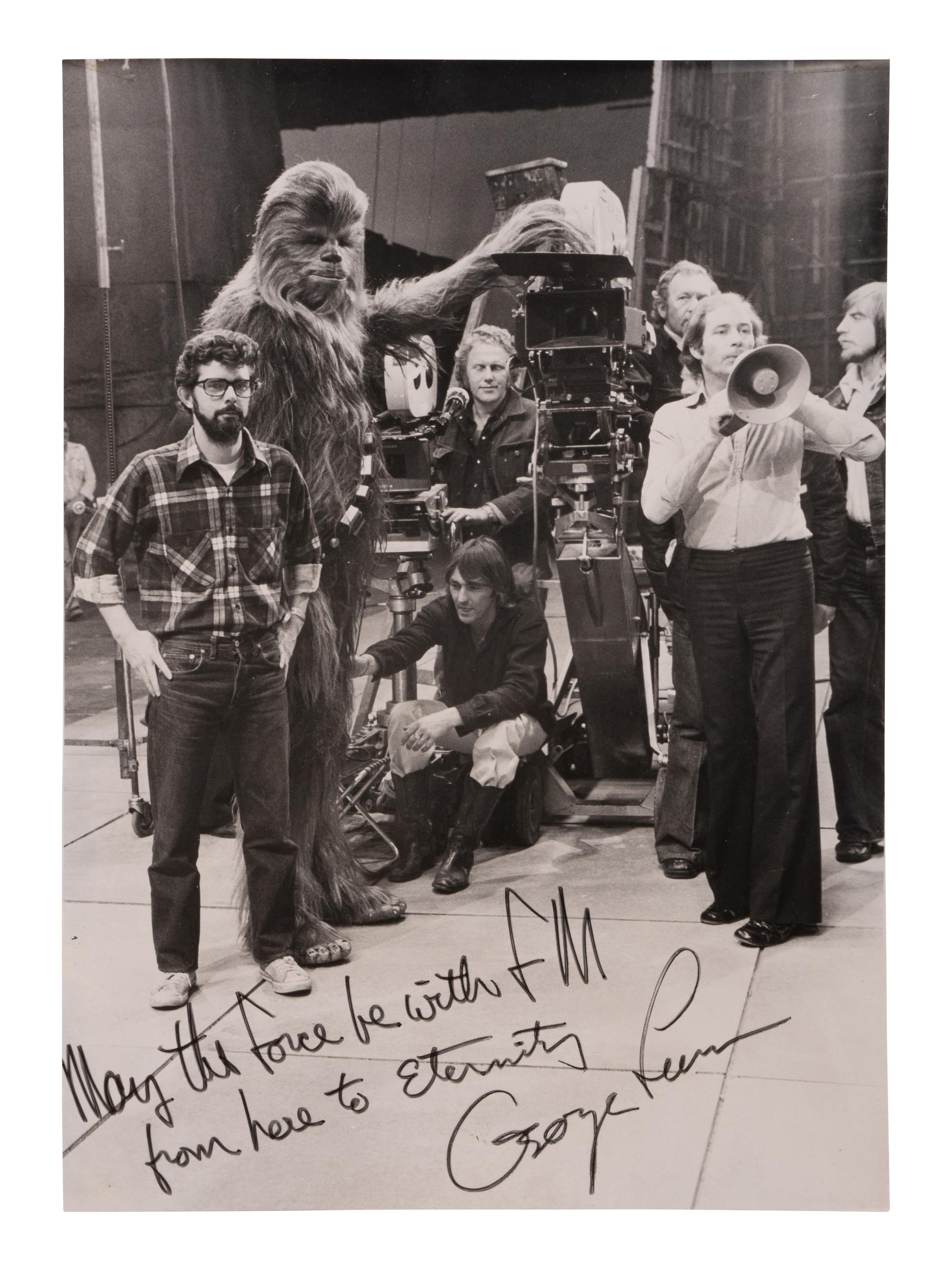 [LUCAS, George (b. 1944)]. Original photograph from the set of Star Wars with personal inscription from George Lucas. 1977.