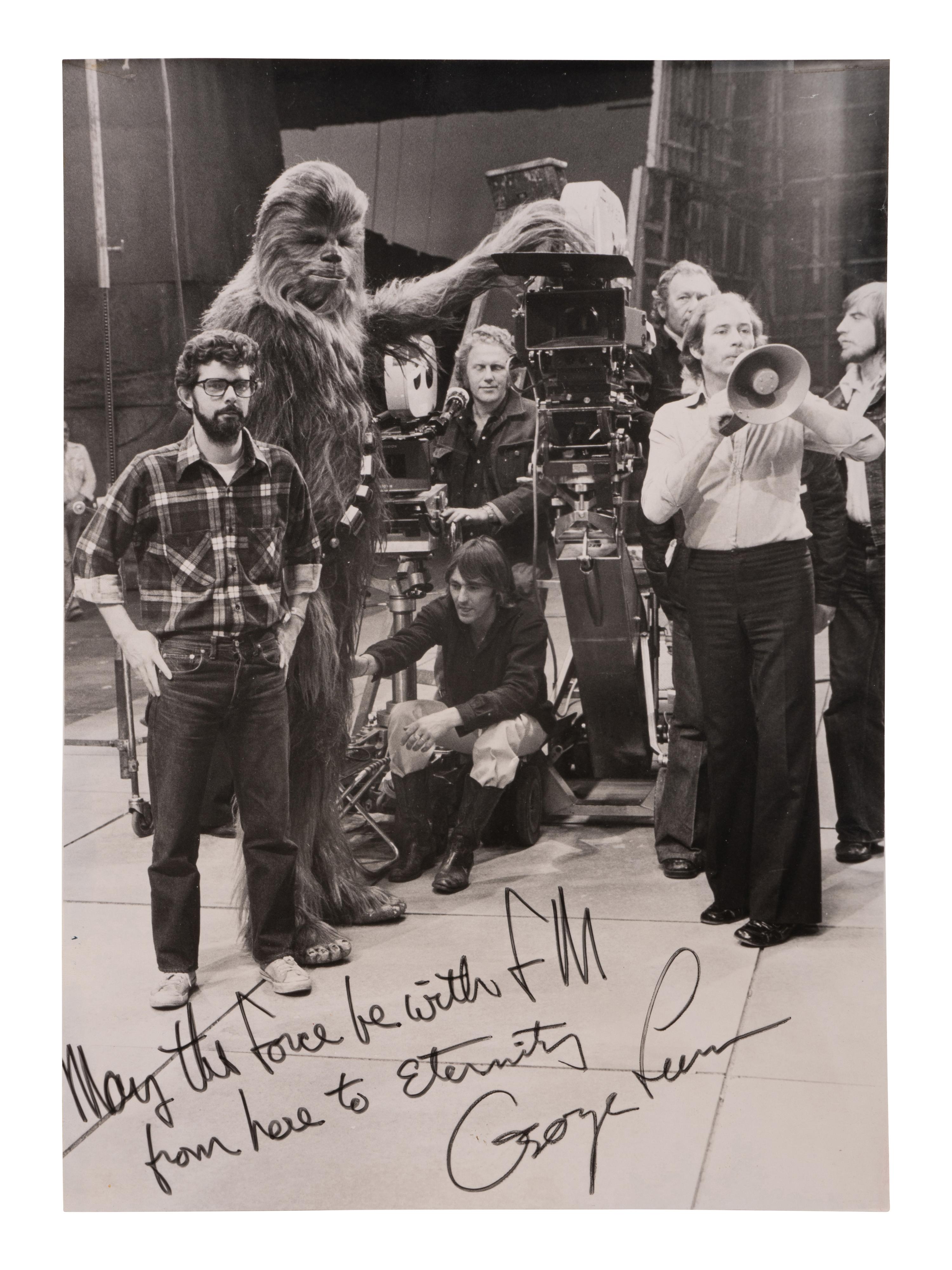 [LUCAS, George (b. 1944)]. Original photograph from the set of Star Wars with personal inscription from George Lucas. 1977.
