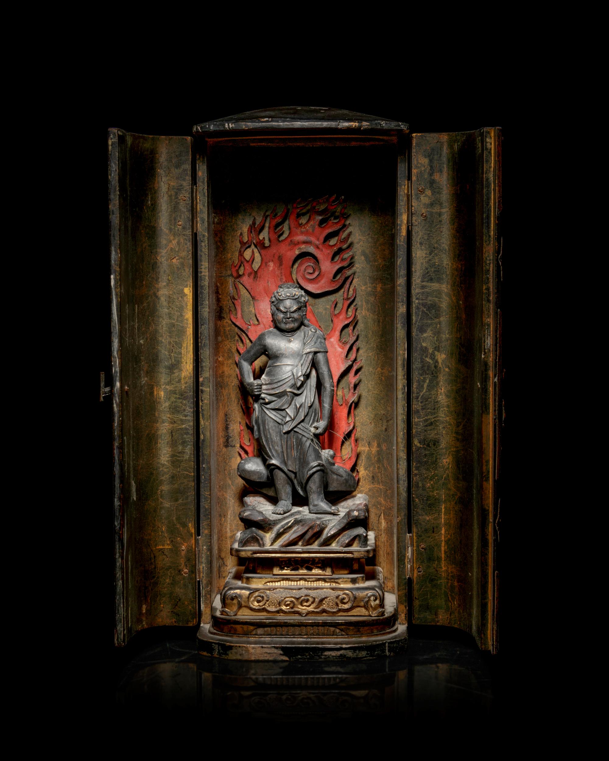 A Black Lacquered Shrine with a Polychrome and Black Painted Wood Figure of a Guardian