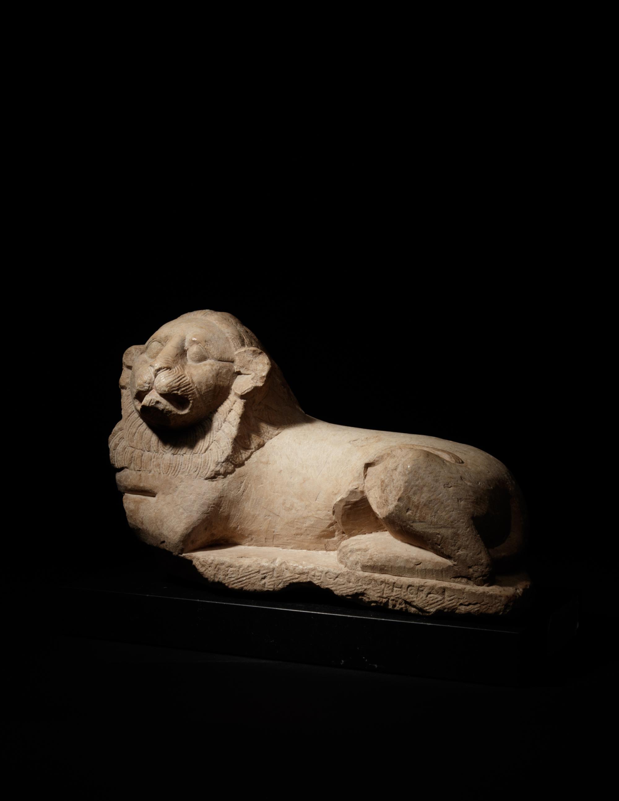 An Egyptian Limestone Recumbent Lion
