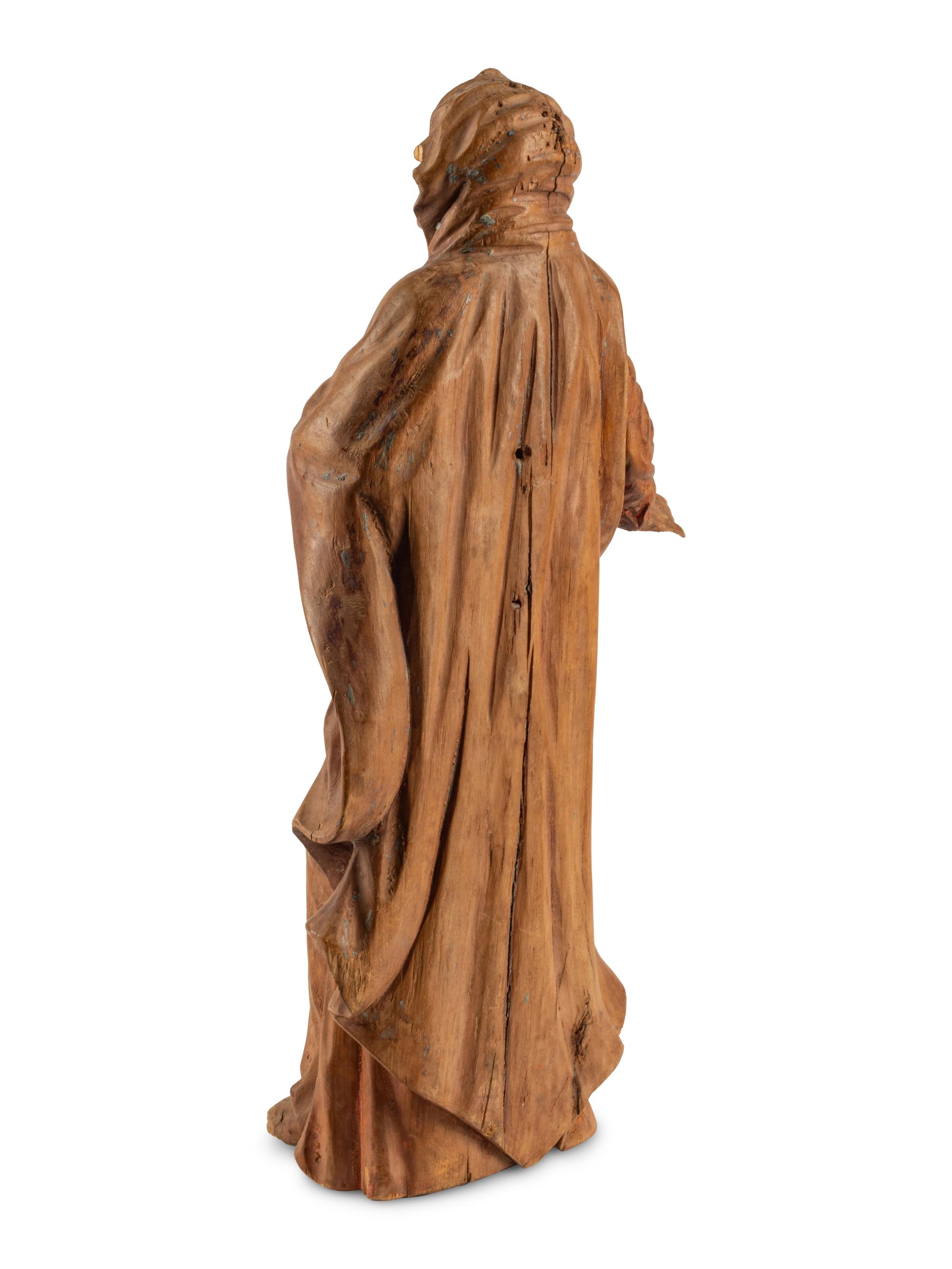 A Continental Carved Fruitwood Saint Figure