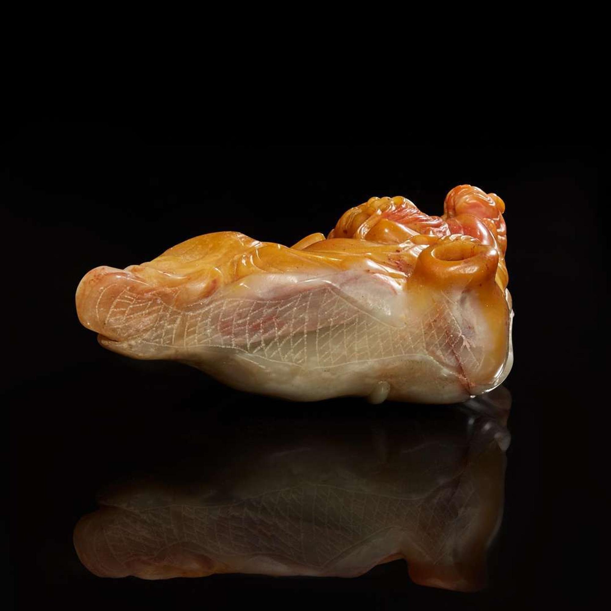 A Chinese carved amber and grey soapstone figure of Li Bai and Lion 壽山石雕李白與小獅