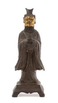 A Chinese Parcel Gilt Bronze Figure of a Daoist Immortal MING DYNASTY, 16TH/17TH CENTURY Height 10 1/4 x width 3 3/4 inches. — MING DYNASTY, 16TH/17TH CENTURY
