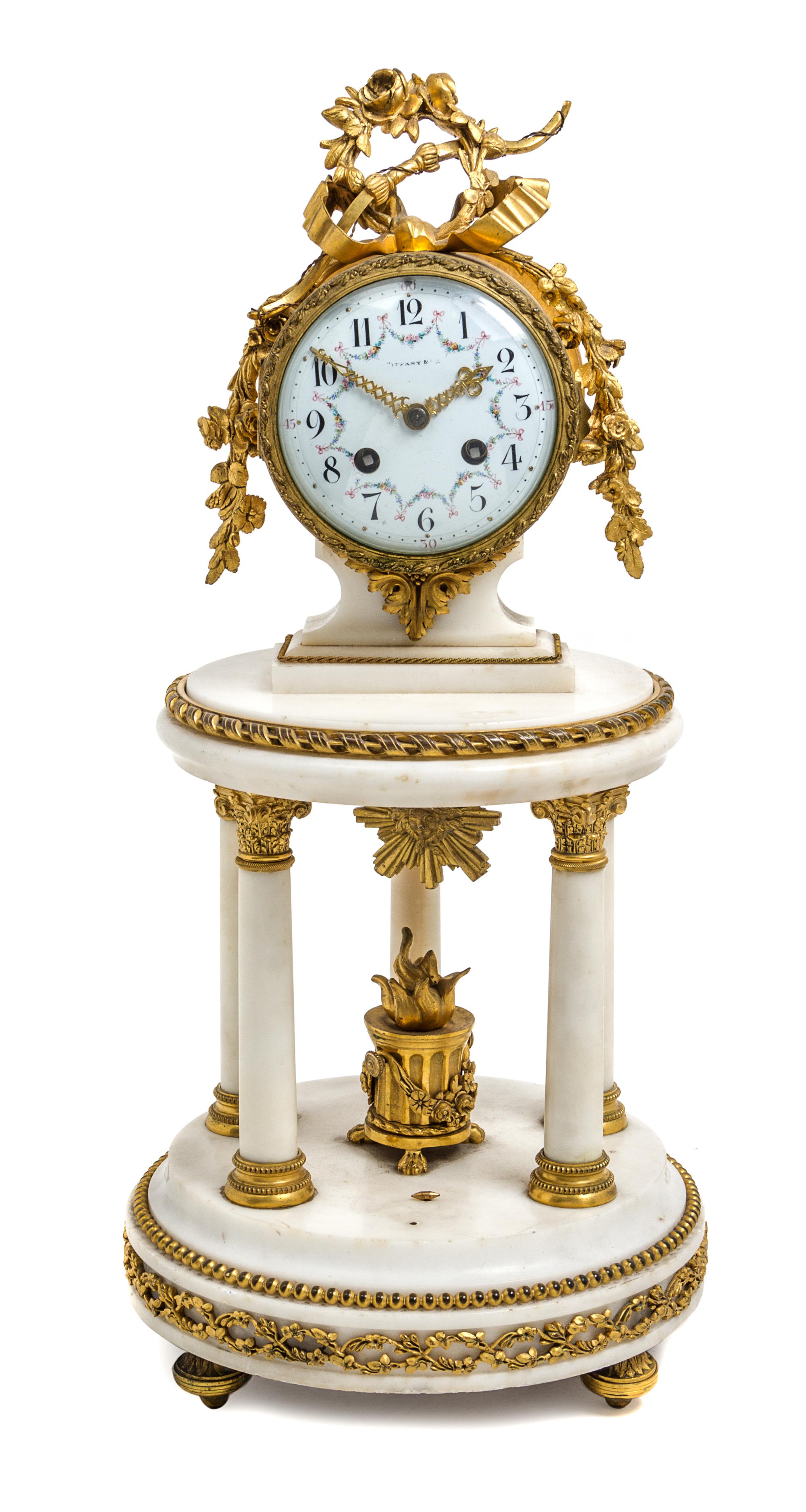 A French Gilt Bronze and Marble Mantel Clock Height 19 1/2 inches. — RETAILED BY TIFFANY & CO., LATE 19TH CENTURY