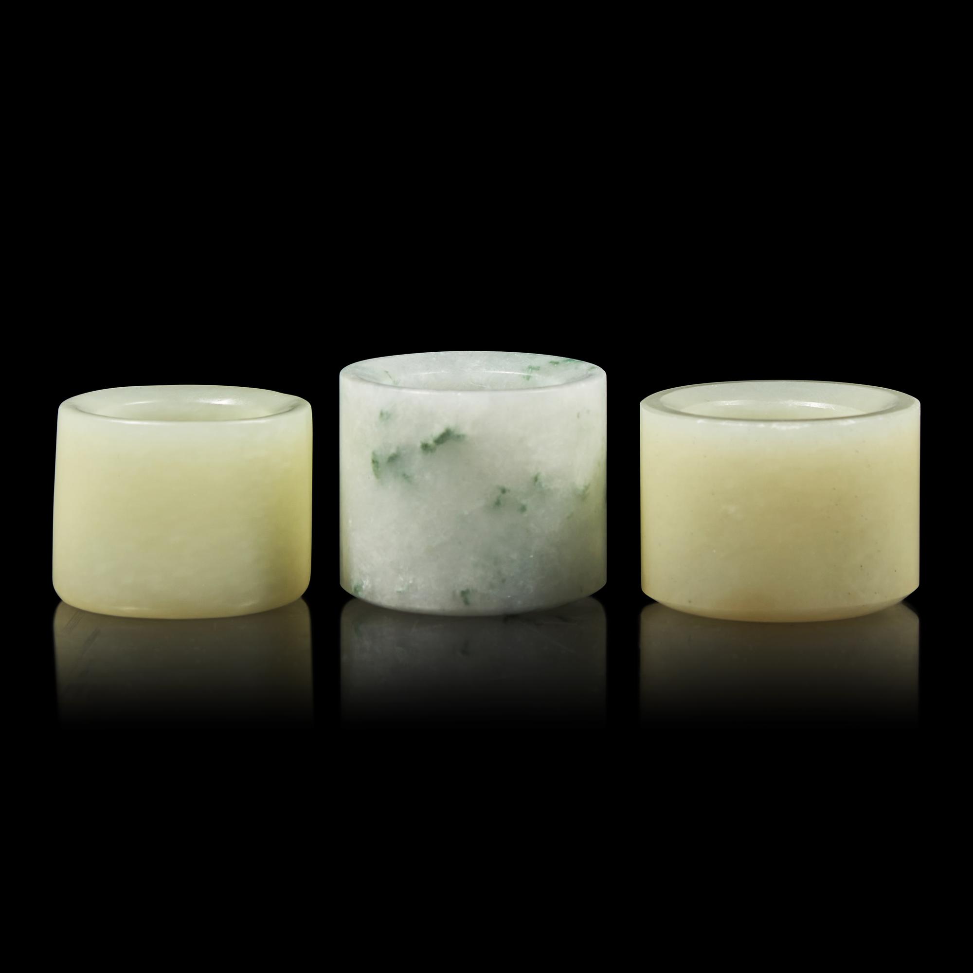 A Group of Three Chinese Jade and Jadeite Archer's Rings 翡翠及玉扳指一組三件