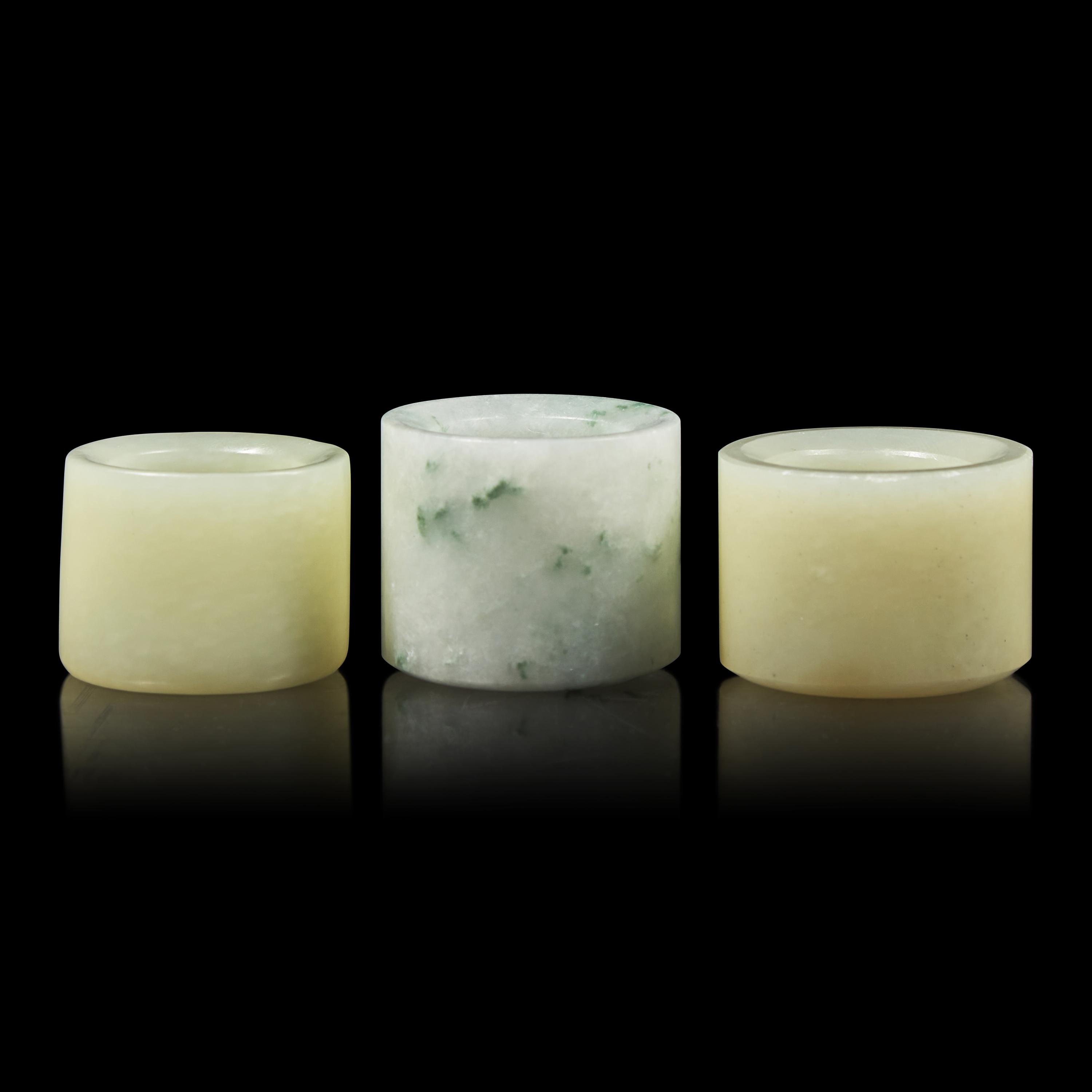 A Group of Three Chinese Jade and Jadeite Archer's Rings 翡翠及玉扳指一組三件