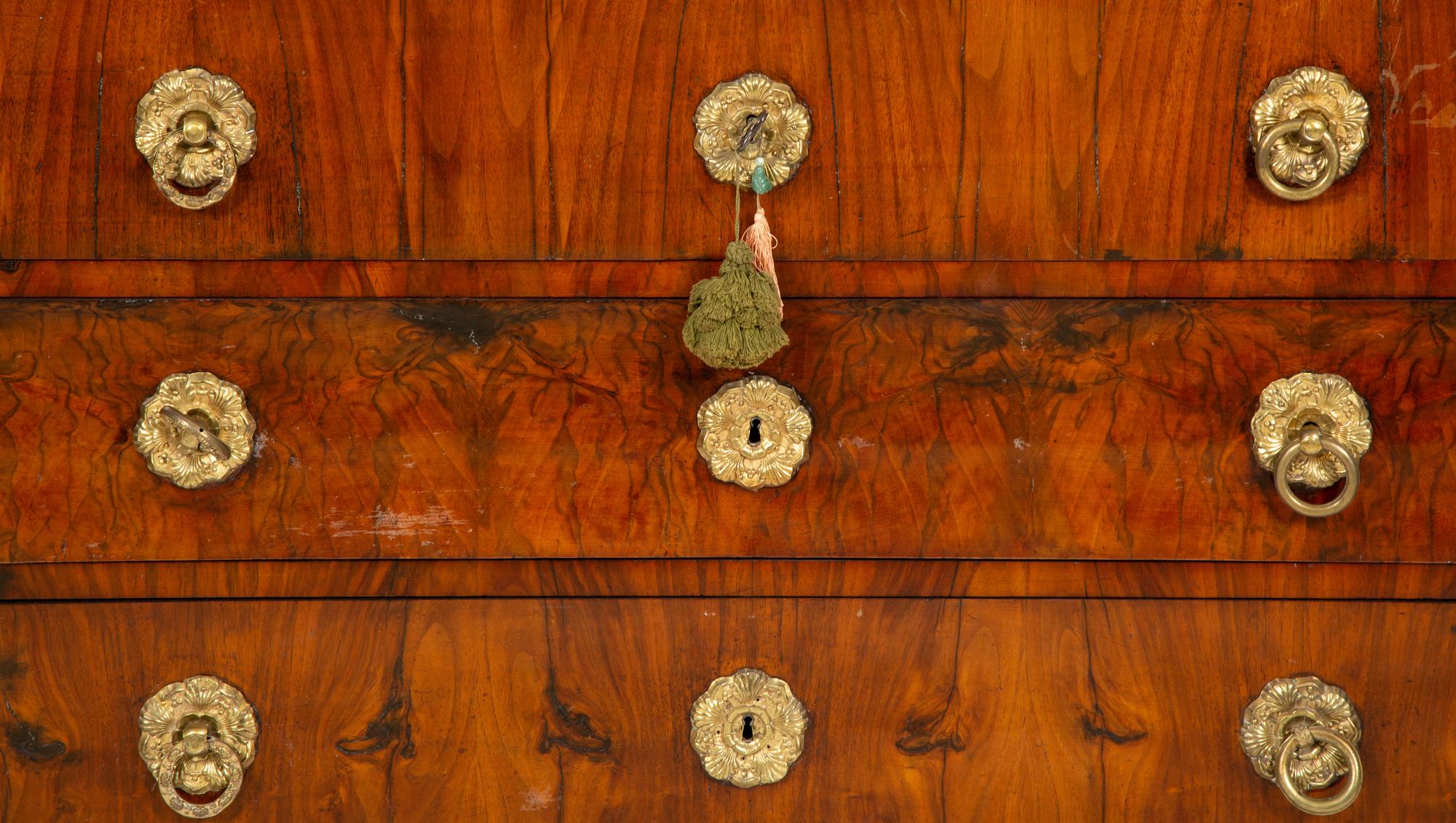 A Biedermeier Walnut Veneered and Grain-Painted Commode