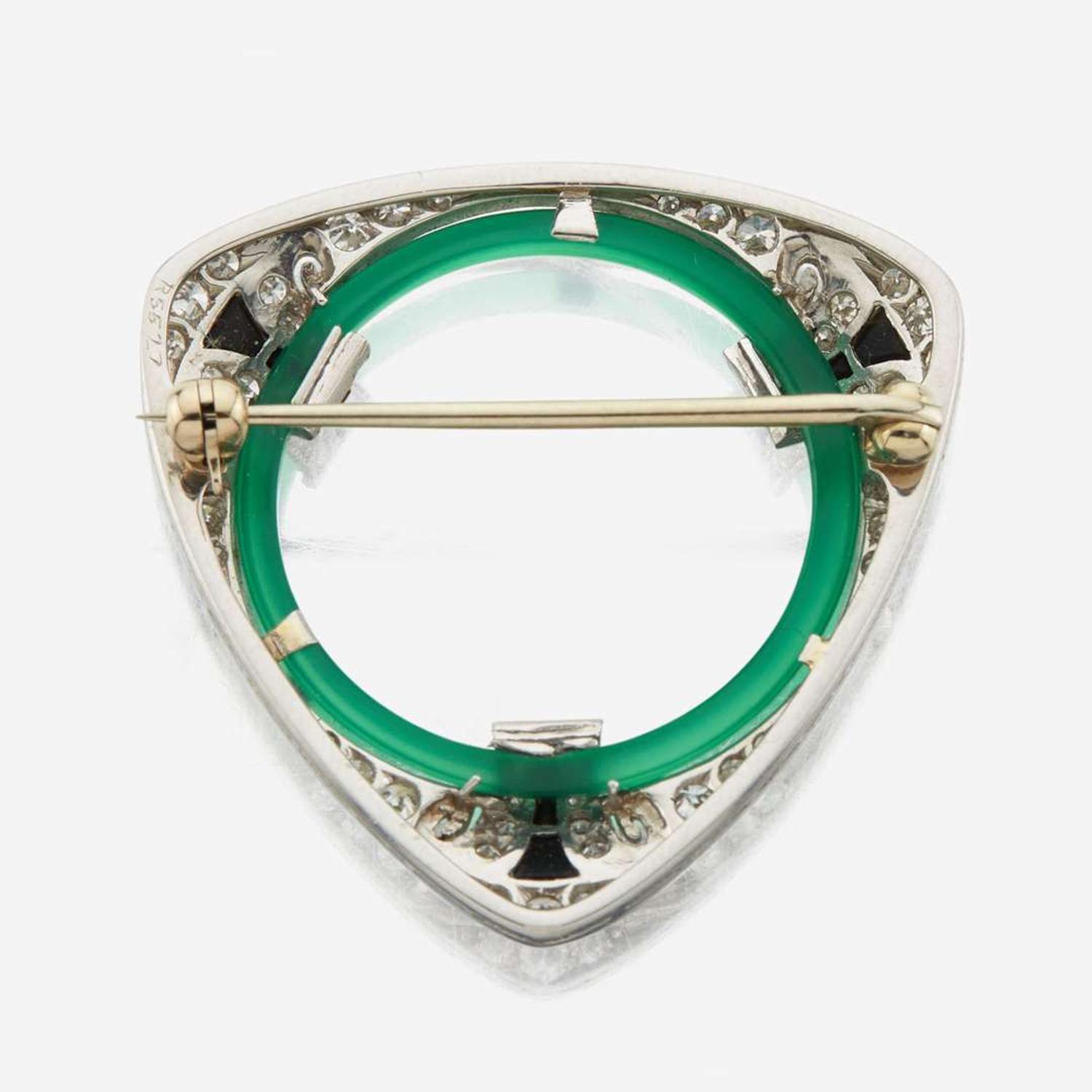 An Art Deco diamond, onyx, green glass, and platinum brooch