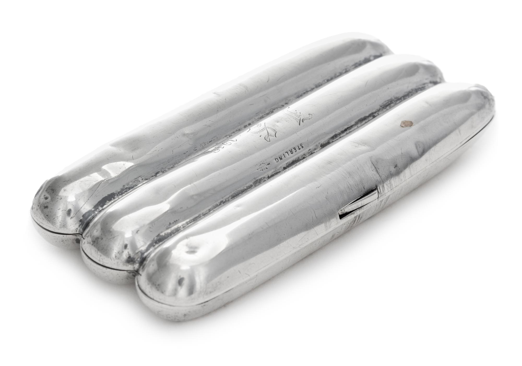 A Silver Cigar Case, , in the form of three cigars, initialed and dated 1913