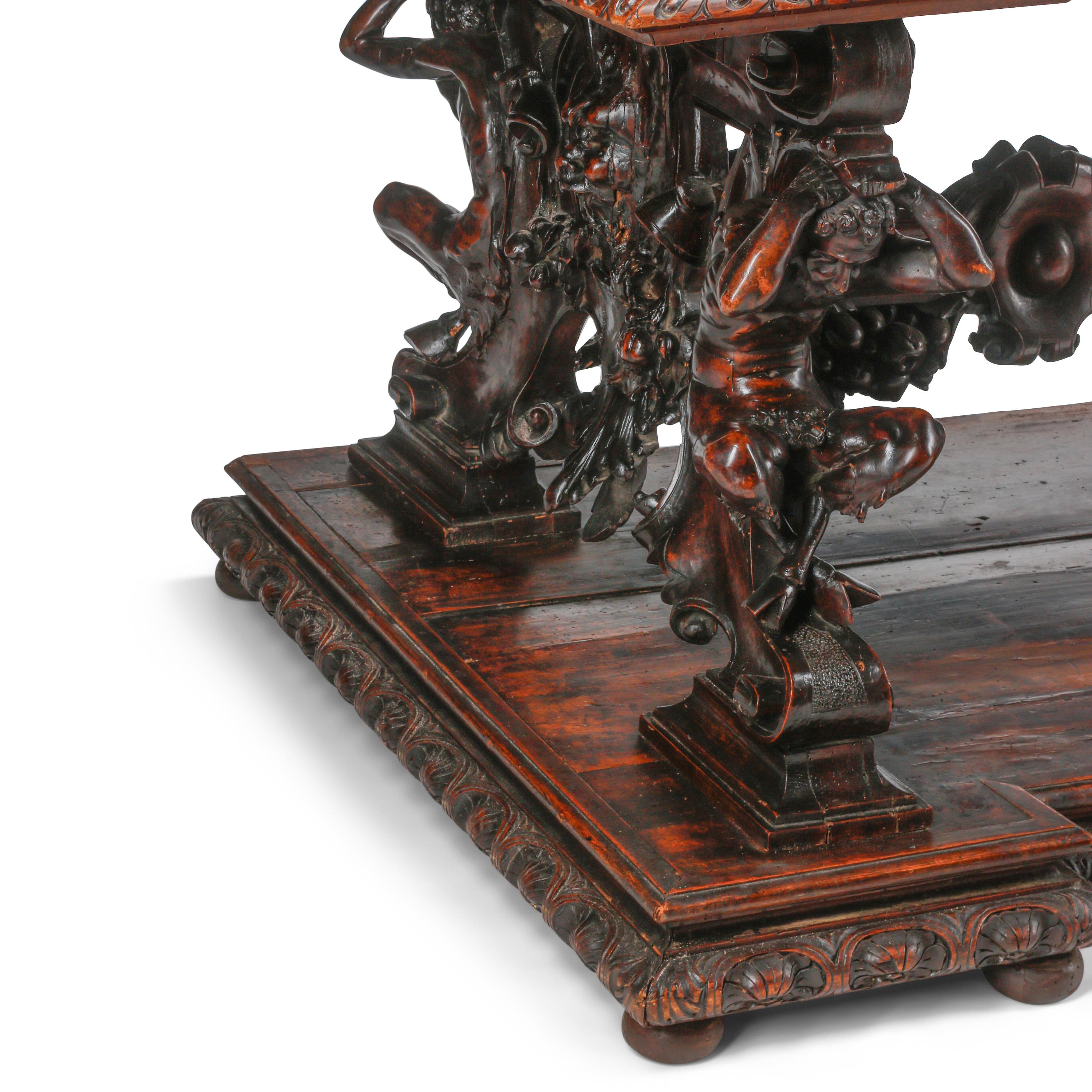 An Italian Renaissance Revival Carved Walnut Library Table