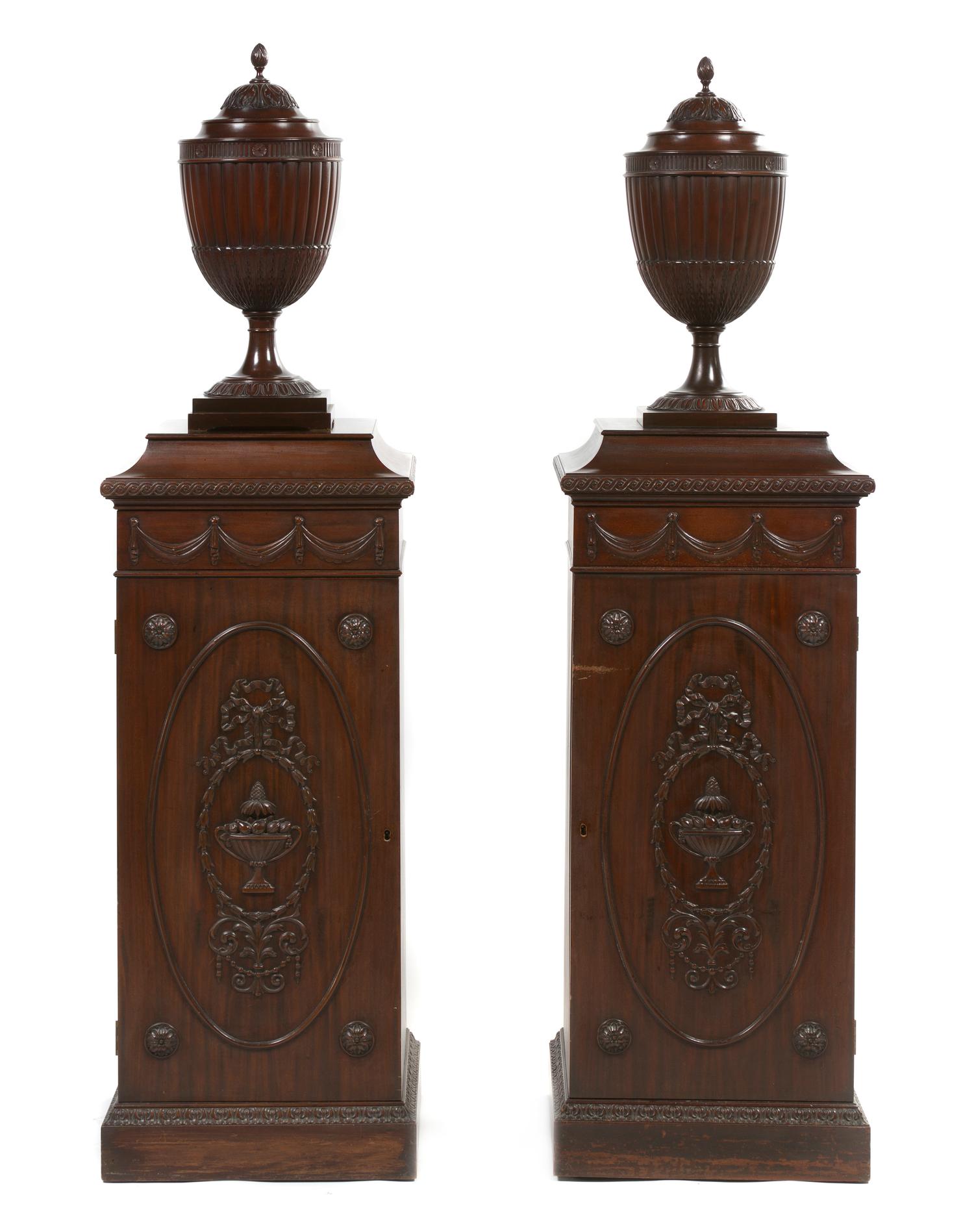 A Pair of George III Style Mahogany Pedestals and Cutlery Urns, Height overall 66 inches.