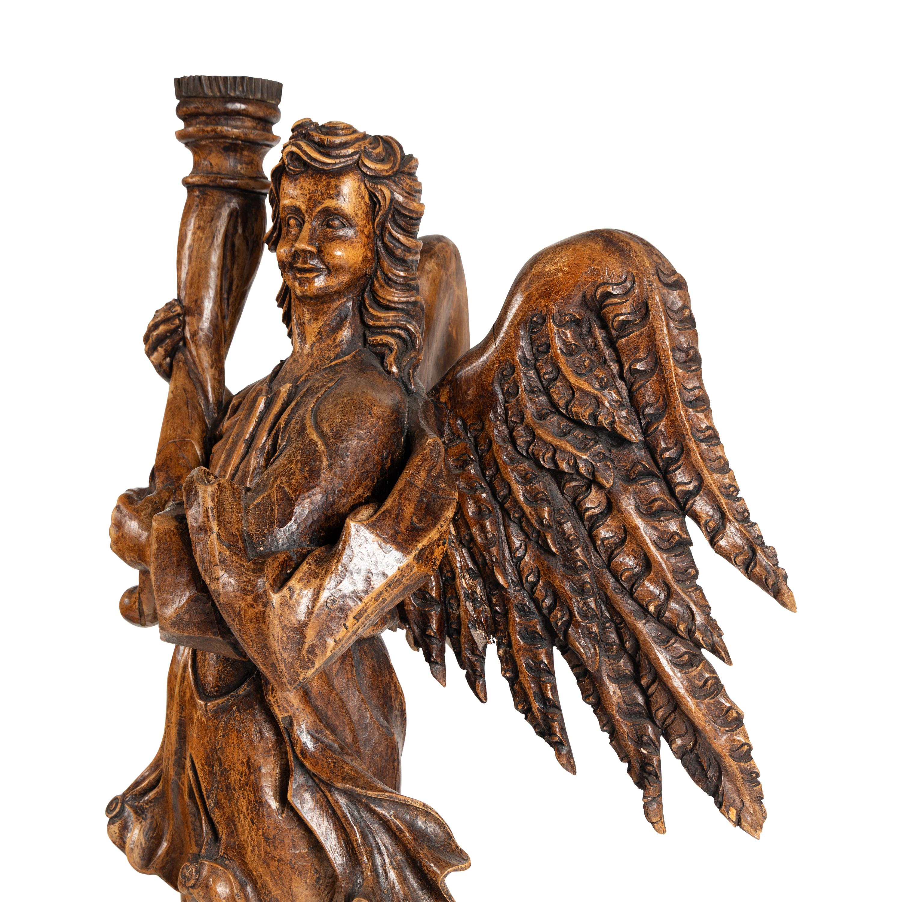 A Pair of Monumental Carved Walnut Figural Torchères