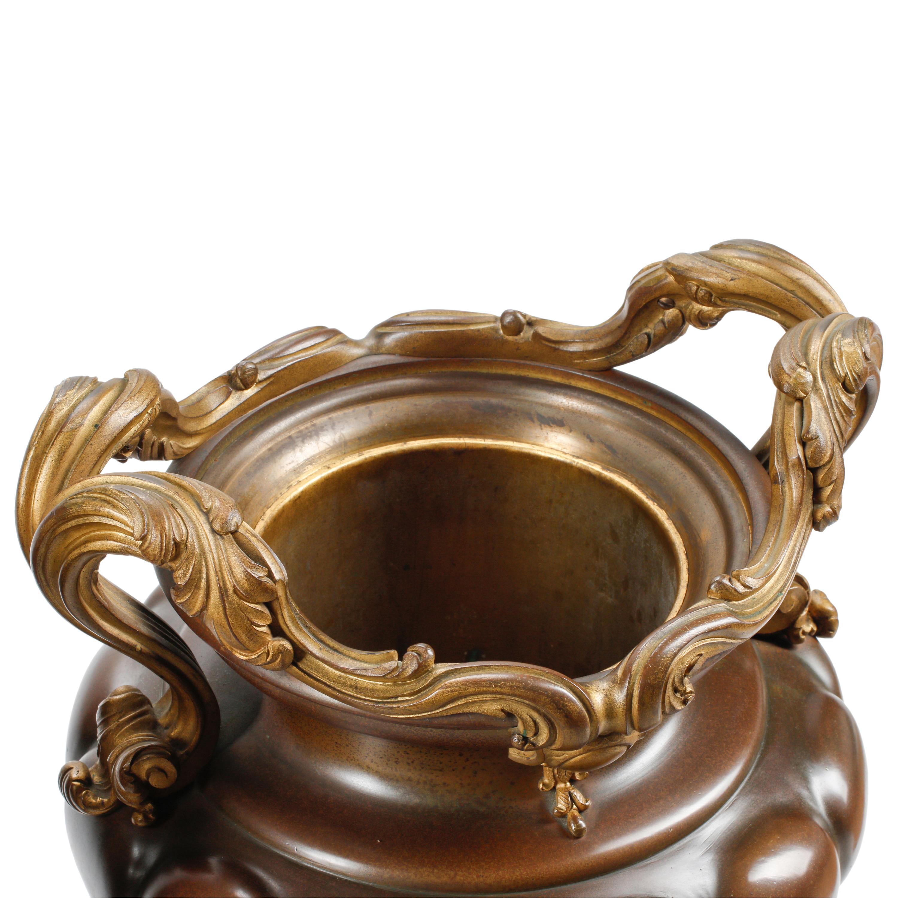 A Pair of French Patinated and Parcel Gilt Bronze Urns