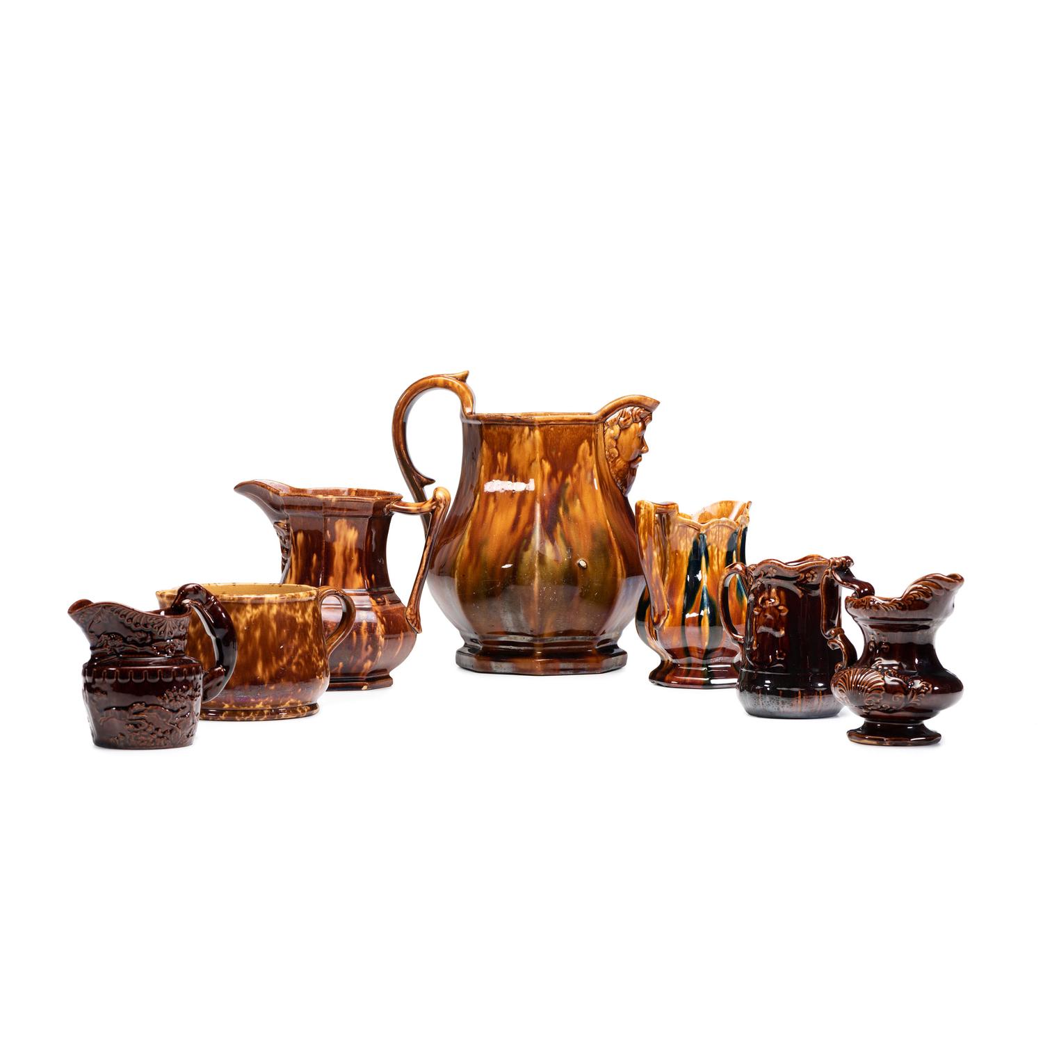 Seven Rockingham Glaze Pitchers