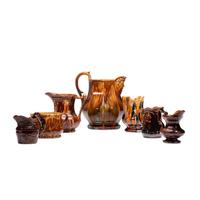 Seven Rockingham Glaze Pitchers