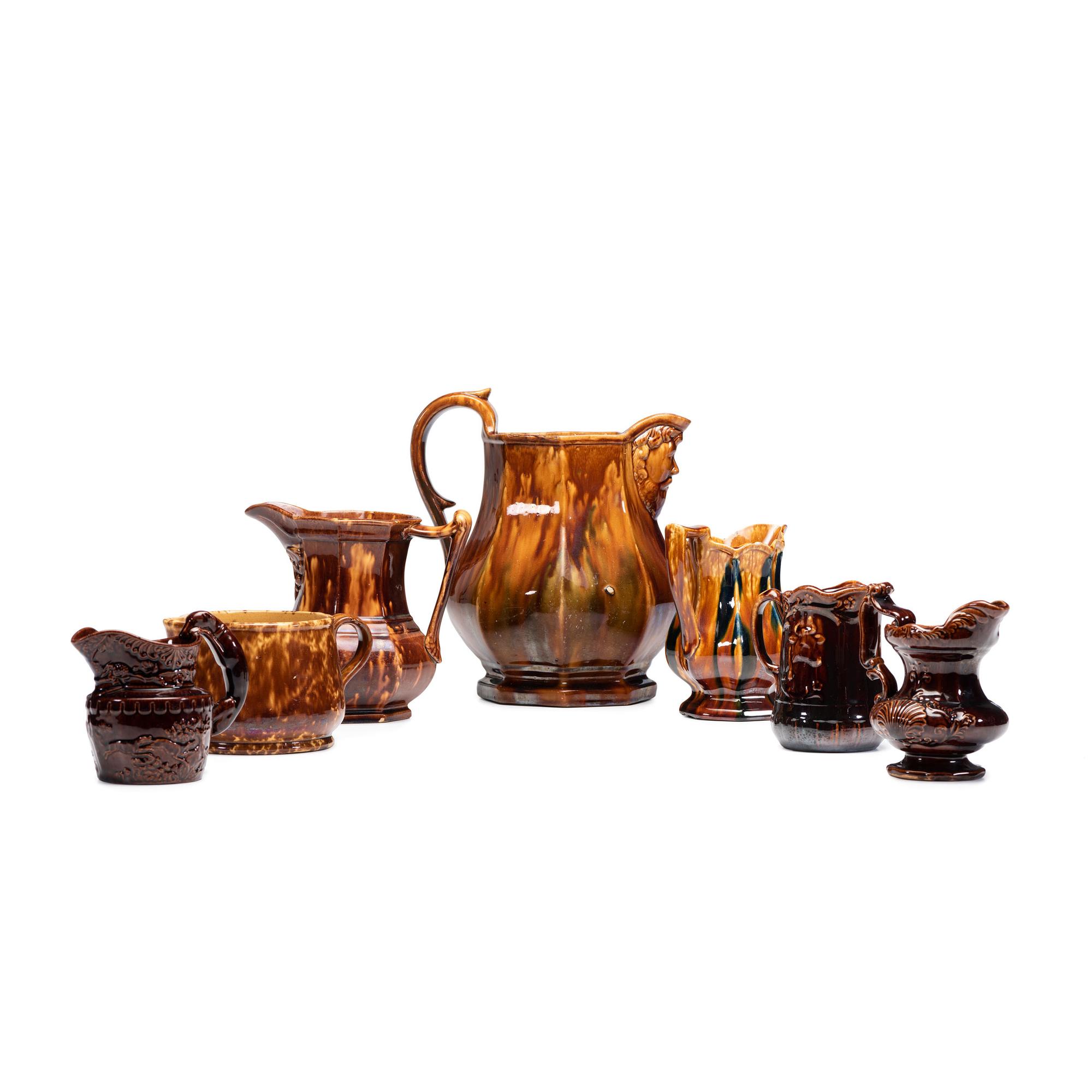 Seven Rockingham Glaze Pitchers