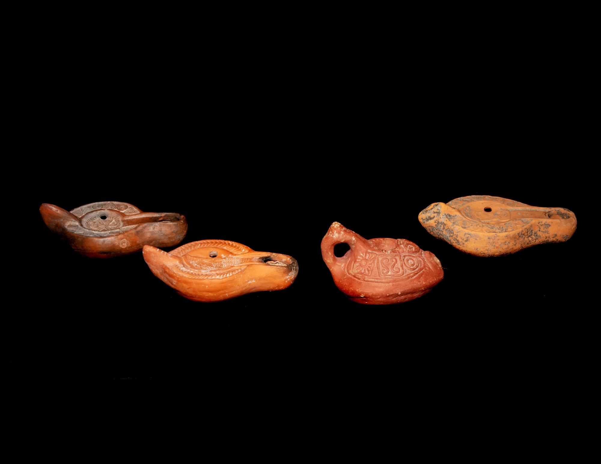Four Roman Molded Terra Cotta Oil Lamps