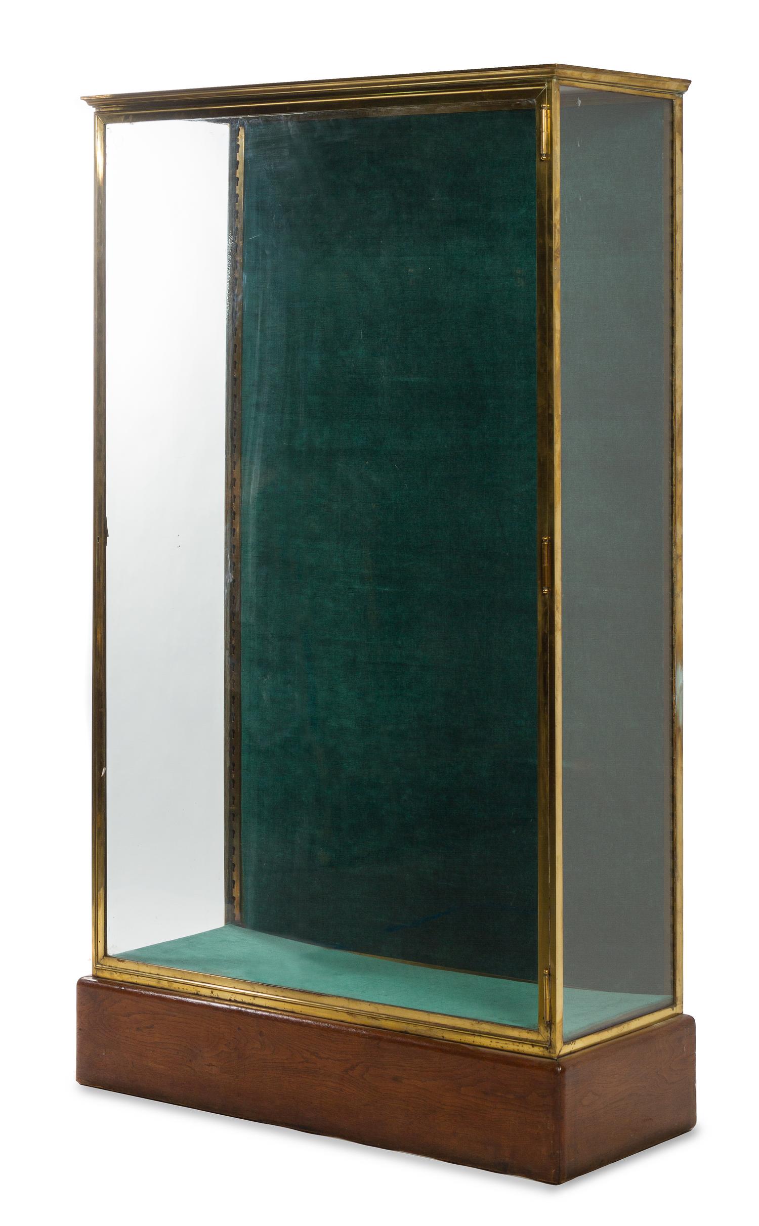 A French Brass and Glass Shop Vitrine Height 71 x width 16 1/4 x depth 42 1/2 inches. — CIRCA 1910