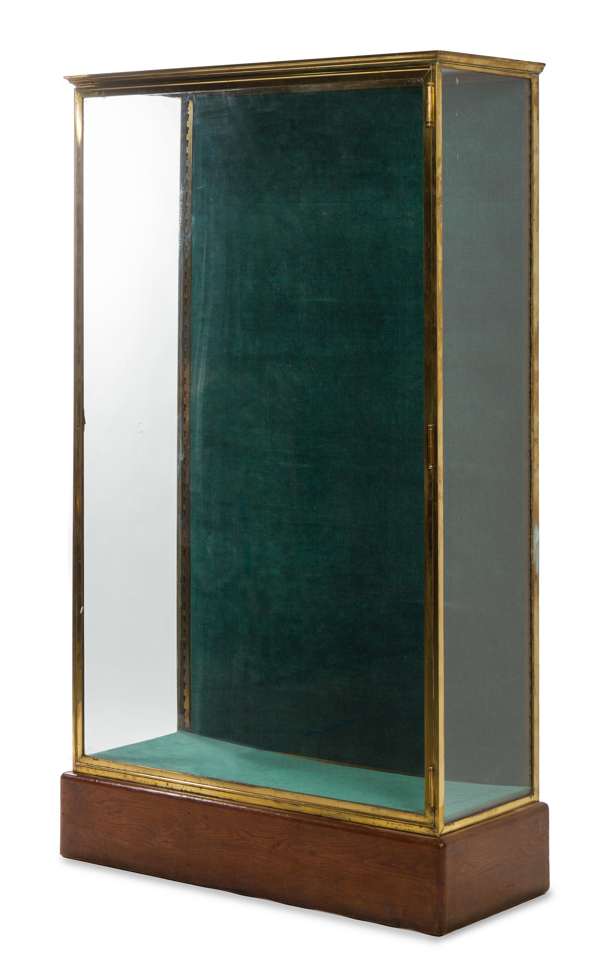 A French Brass and Glass Shop Vitrine Height 71 x width 16 1/4 x depth 42 1/2 inches. — CIRCA 1910