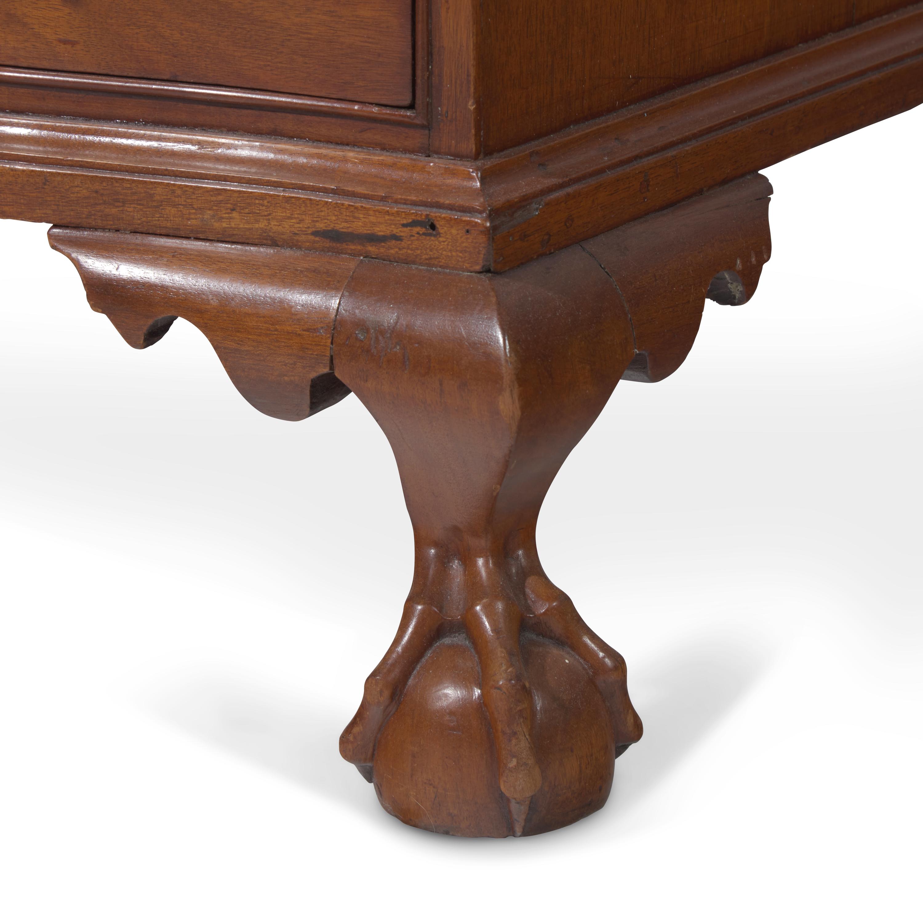 A Chippendale Figured and Shell-Carved Mahogany Reverse-Serpentine Chest of Drawers