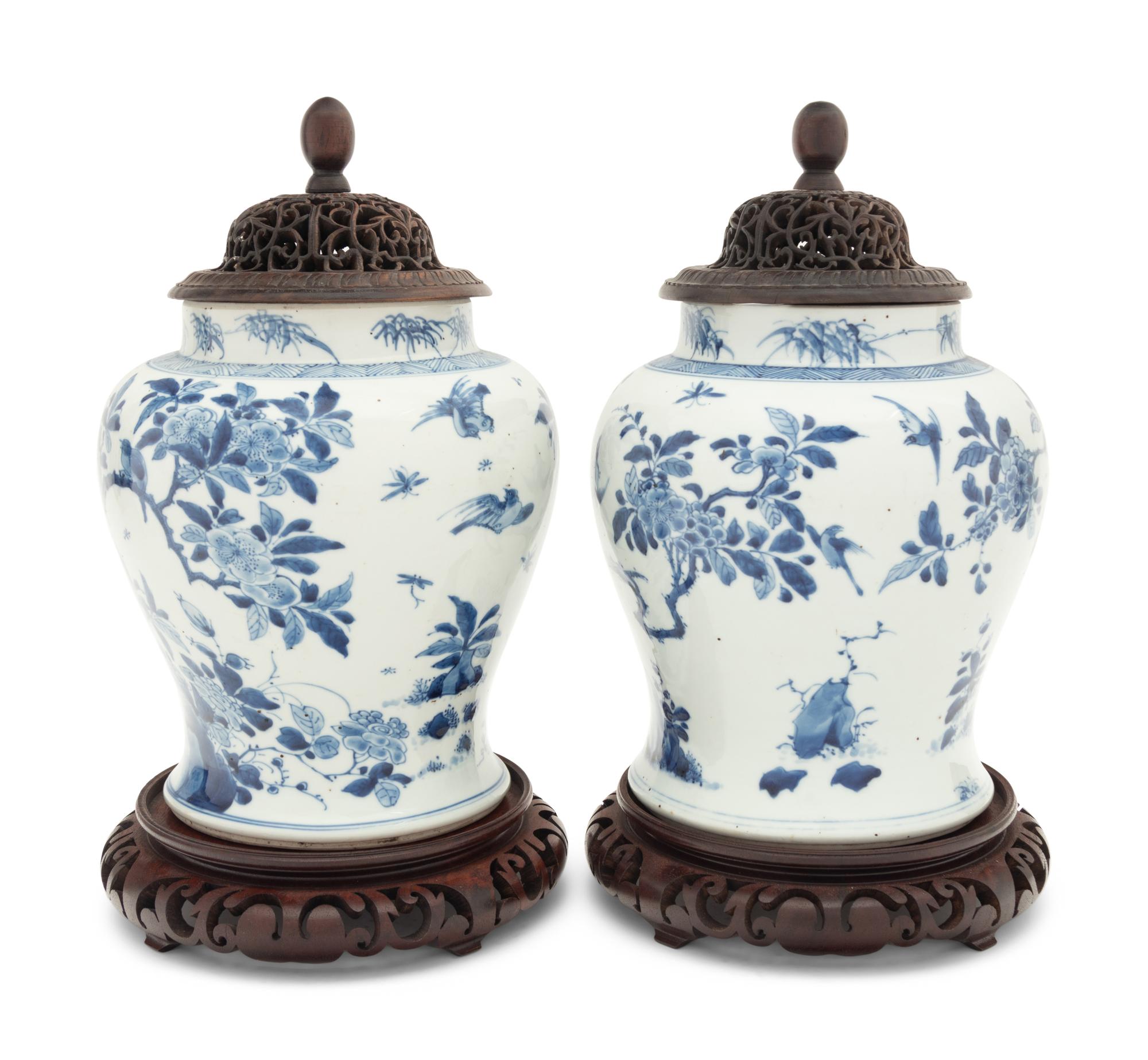 A Pair of Chinese Blue and White Porcelain Ginger Jars with Pierced Wood Lids and Stands